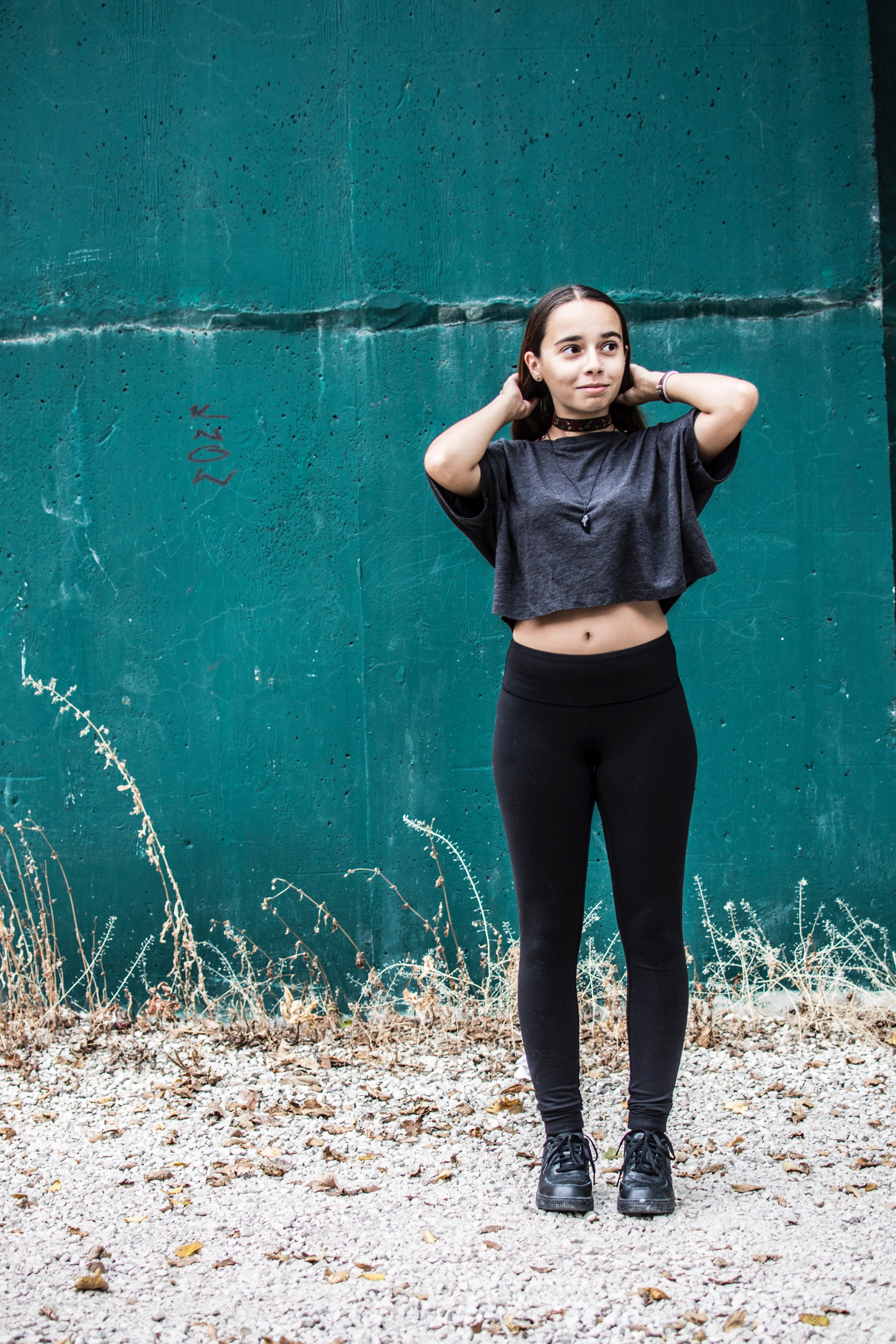 Woman wearing black crew-neck crop-top and black high-waist fitted leggings photo