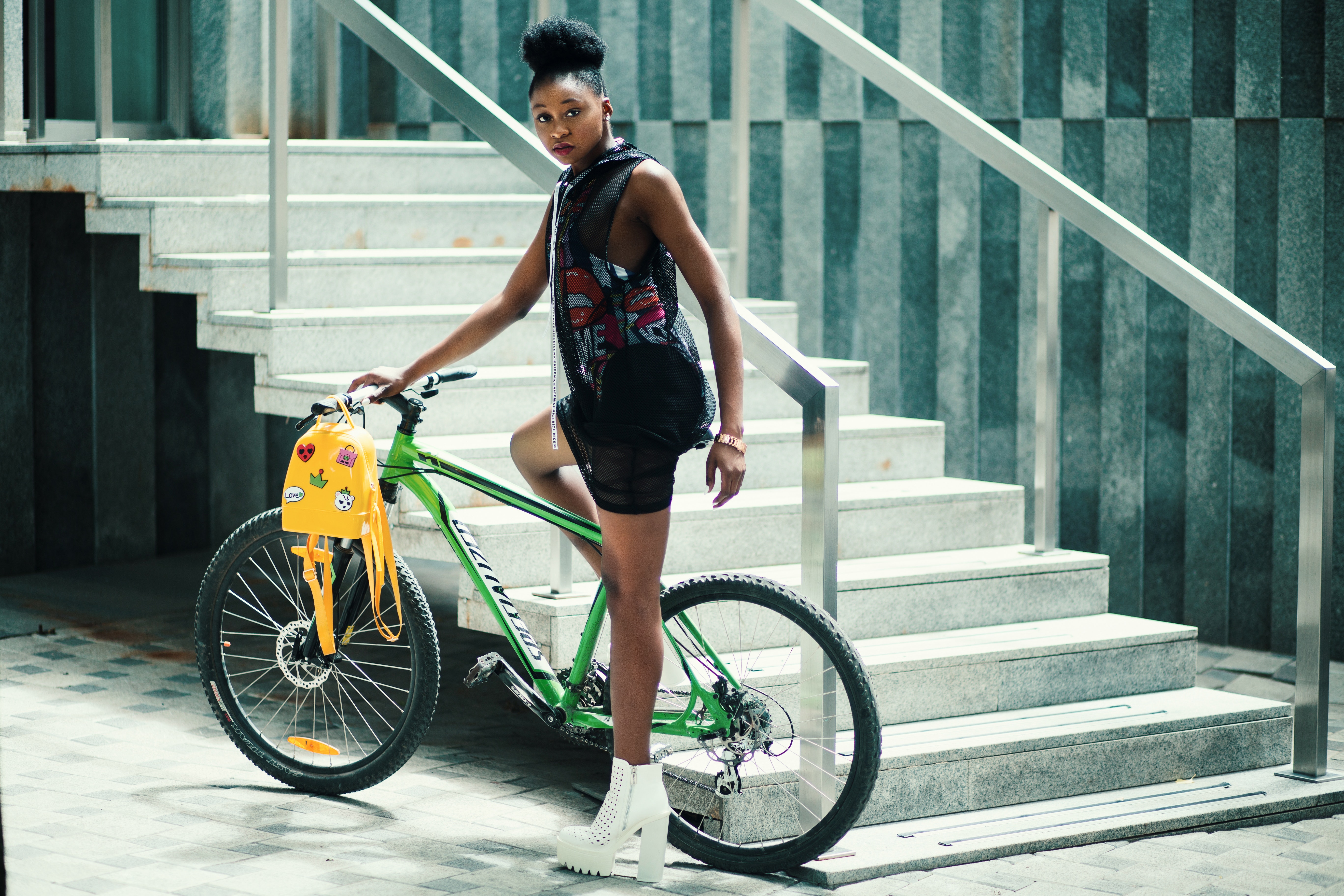 Woman Wearing Black Dress Riding Bicycle Near Stairs, African, Seated, Young, Yellow, HQ Photo