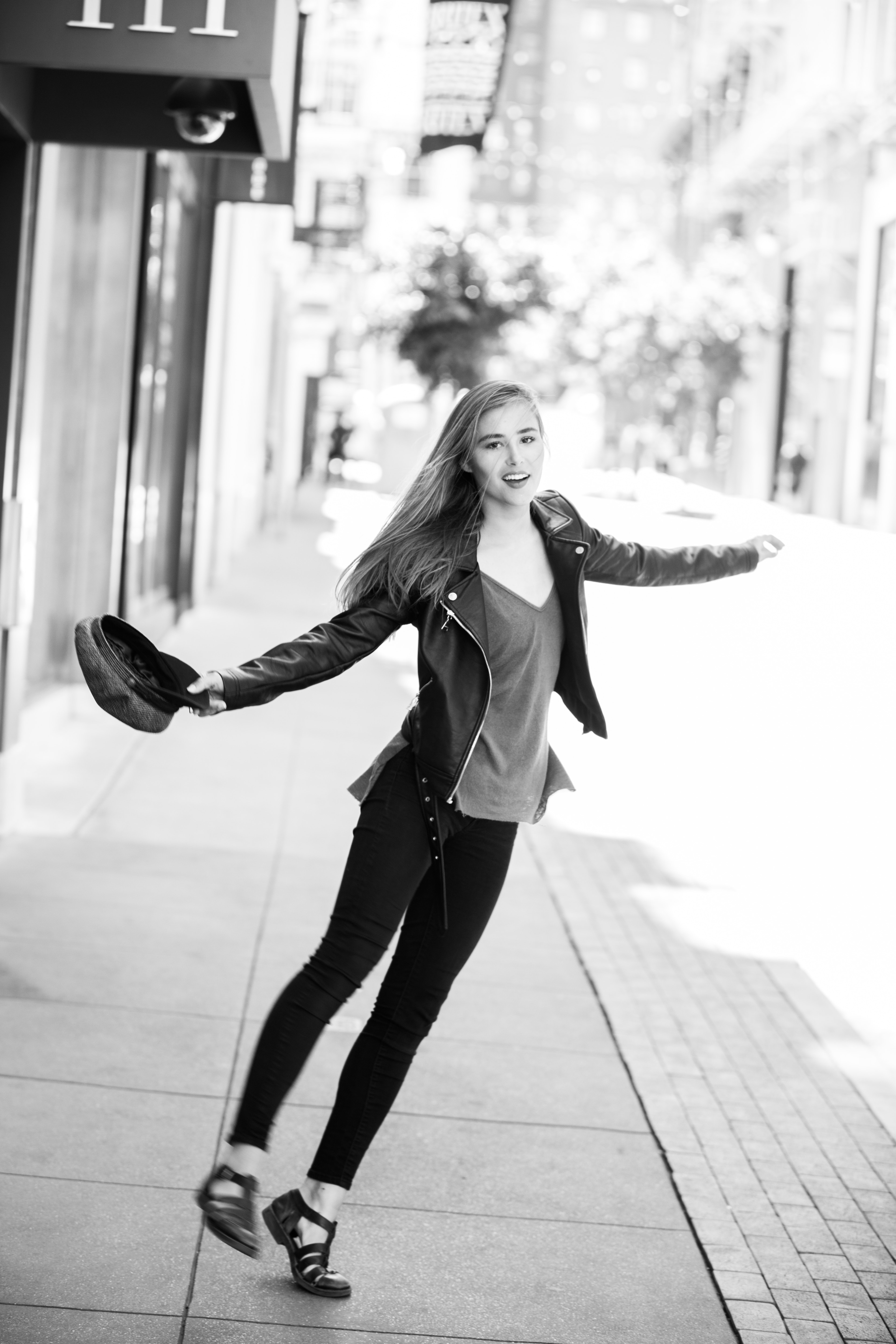 Woman wearing black leather jacket grayscale photo