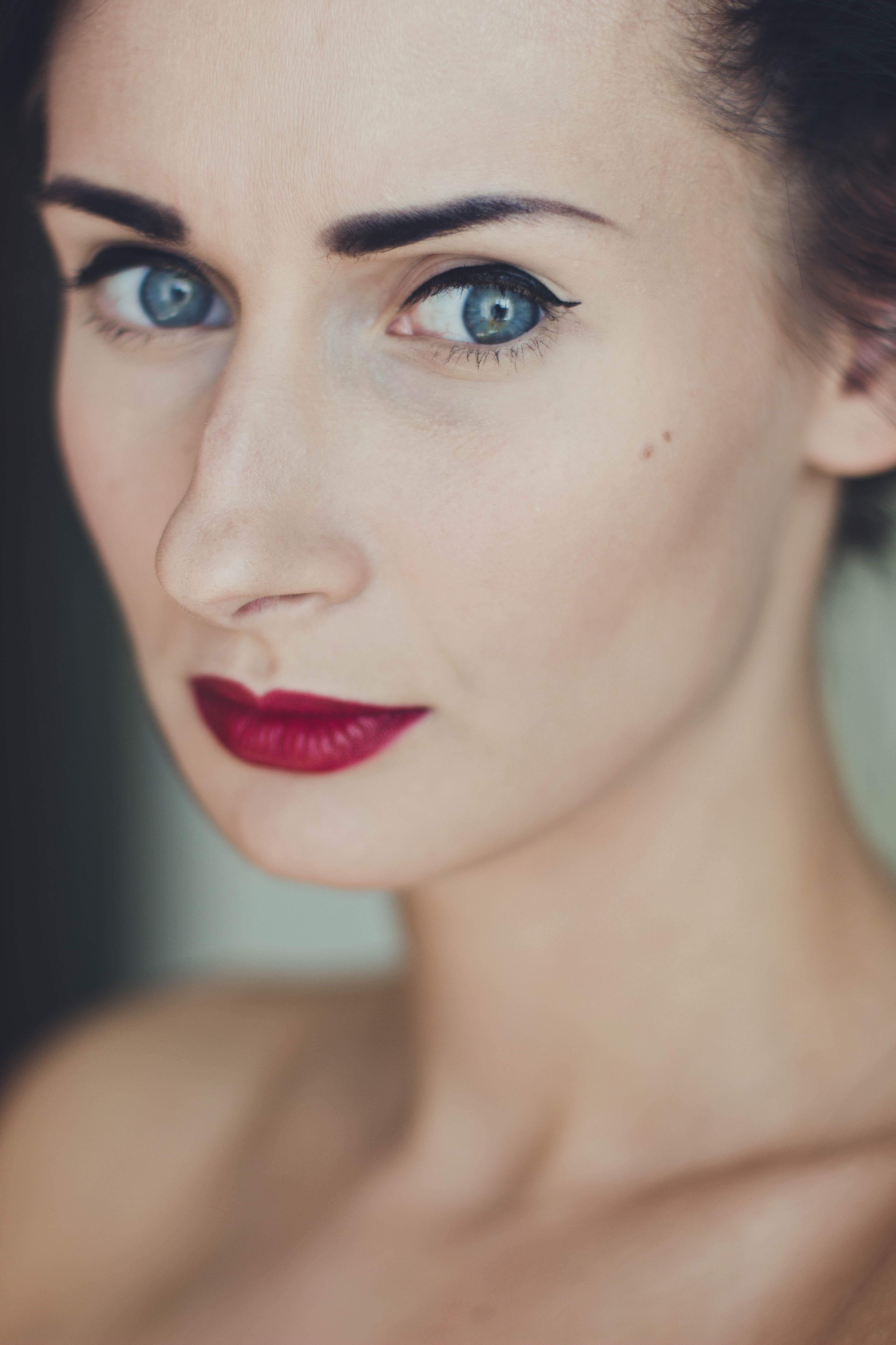 Woman wearing black mascara and red lipstick photo