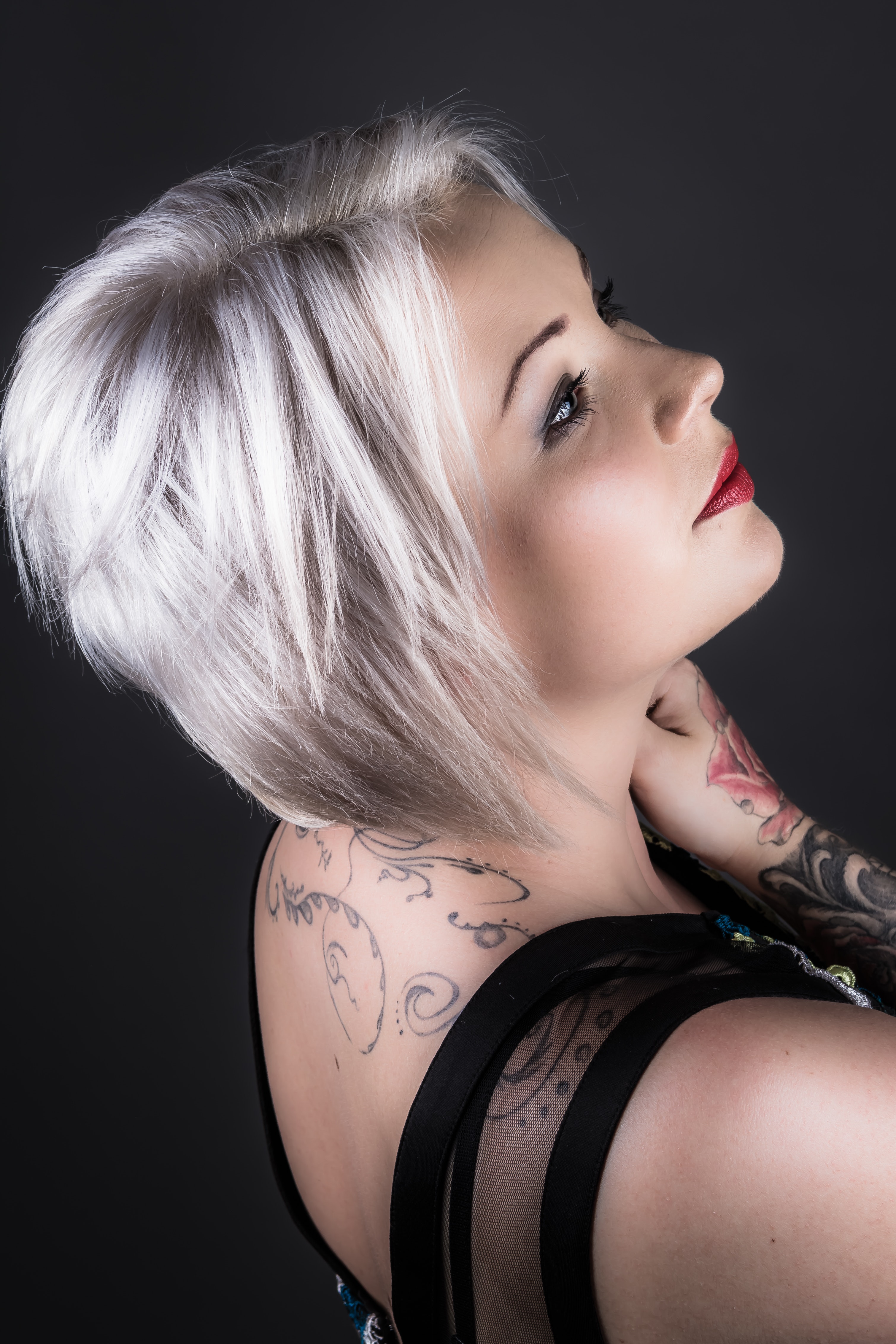 Woman wearing black shirt with tattoo and red lipstick photo