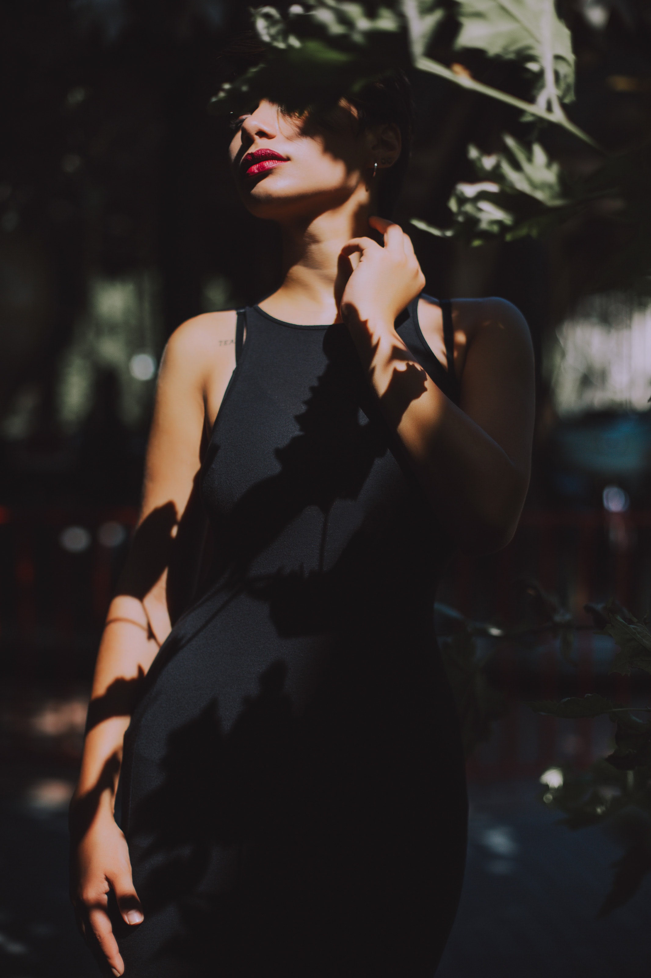 Woman wearing black sleeveless top dress under the tree photo