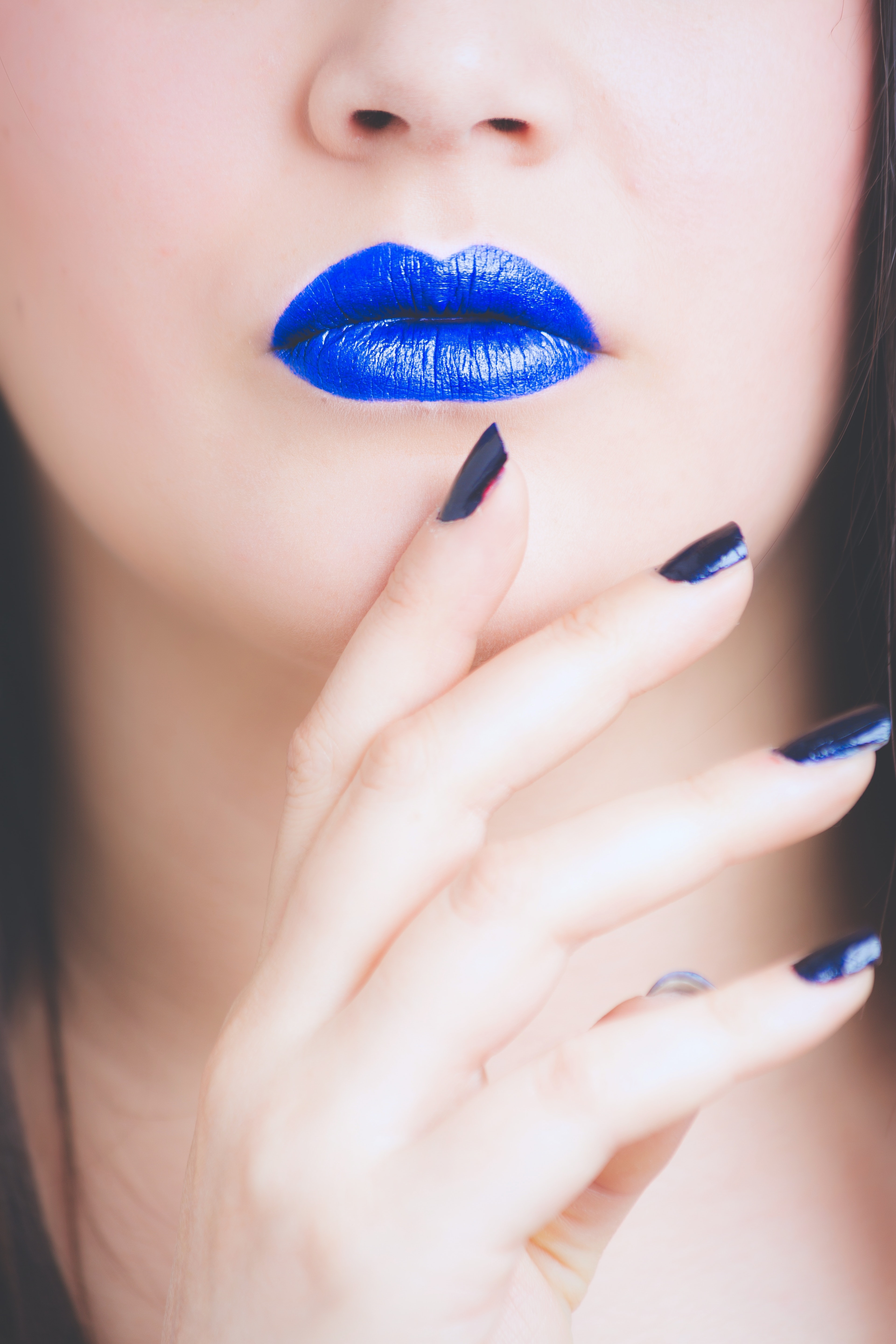 Woman wearing blue lipstick and manicure photo