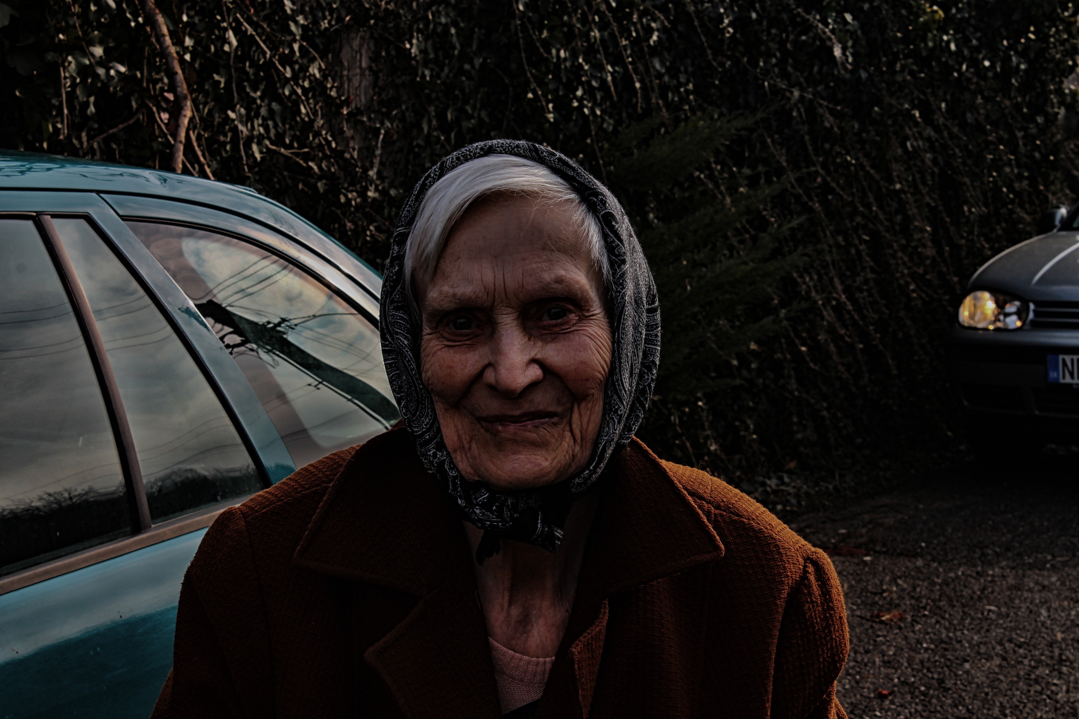 Woman wearing brown jacket and black head scarf photo