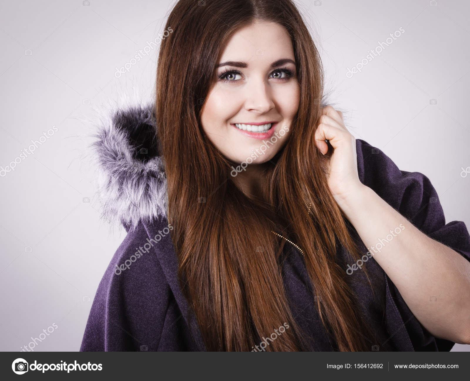 Happy woman wearing dark poncho with hood — Stock Photo © Voyagerix ...