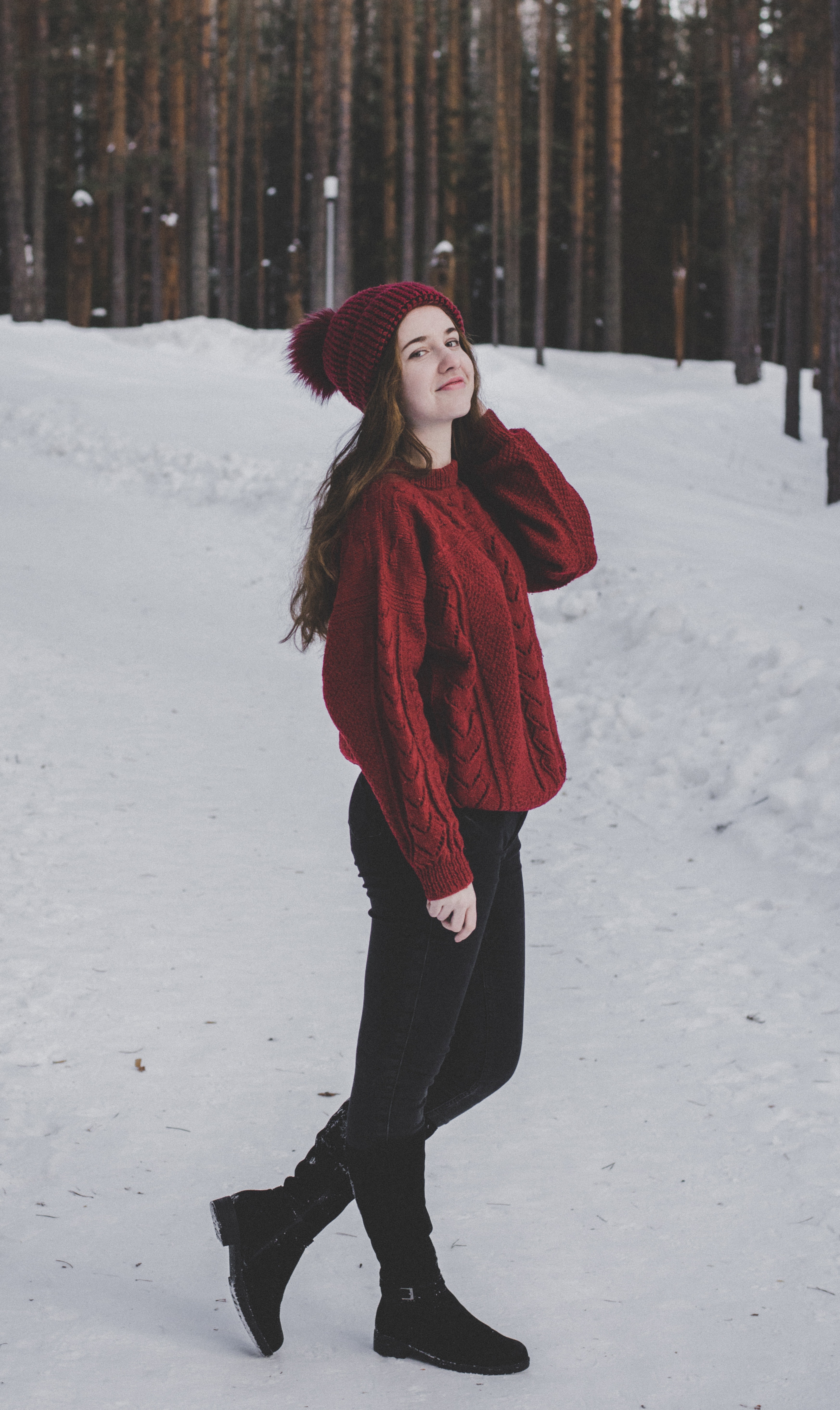 Woman wearing knitted sweater with hat on snowfield photo