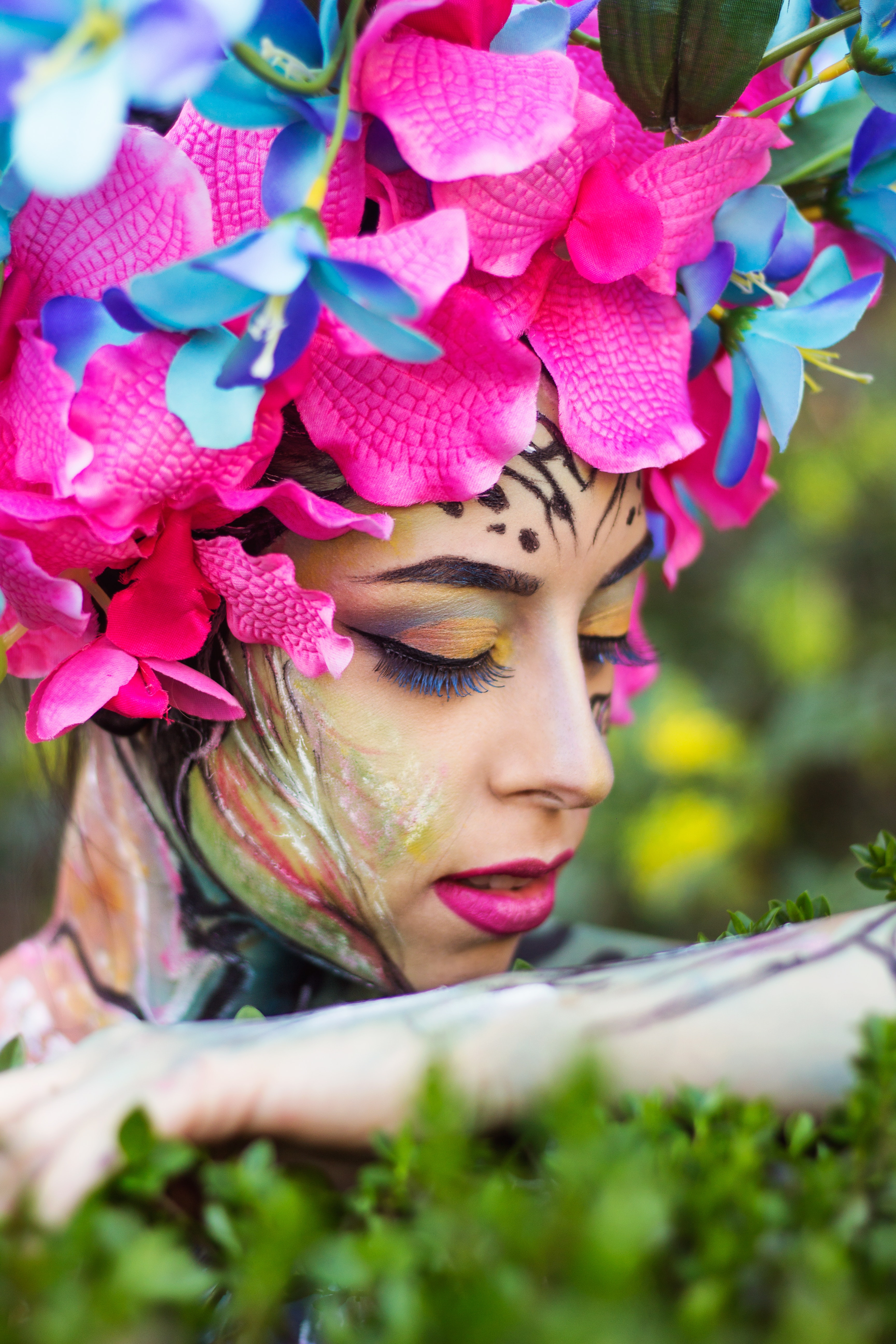 Woman wearing pink petaled flower head dress photo