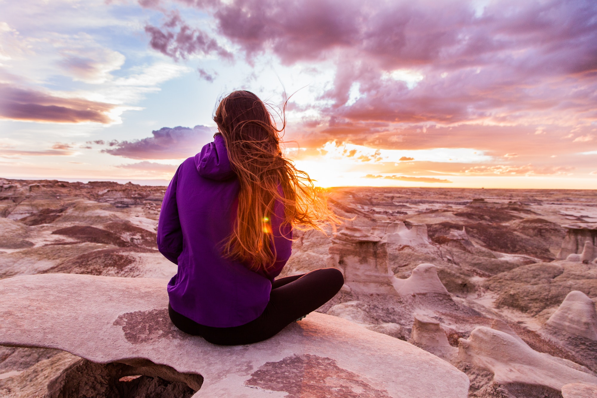 Woman Wearing Purple Hooded Jacket Sitting on Rock, Clouds, Sand, Sunset, Sun, HQ Photo