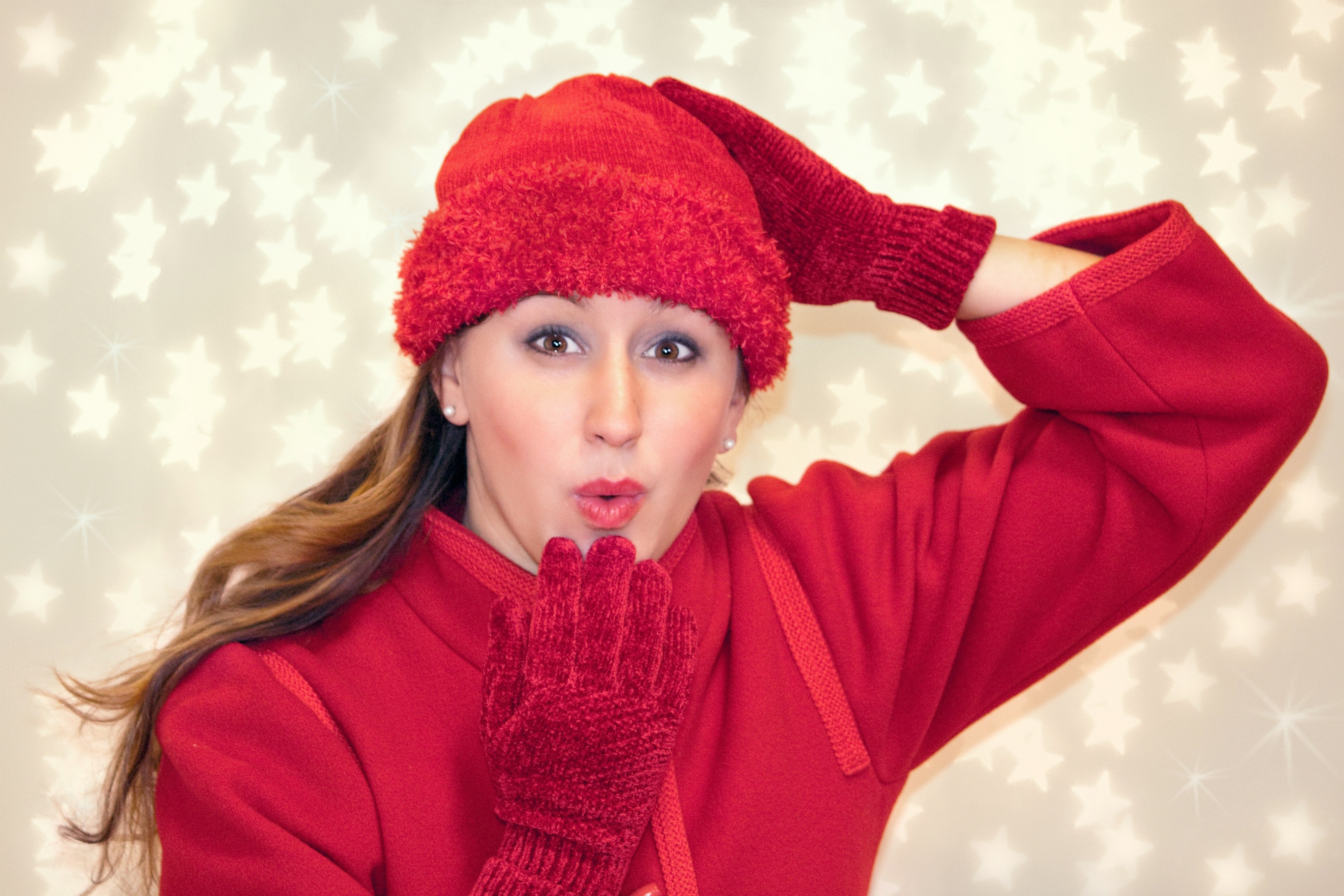 Woman wearing red knitted hat doing pose photo