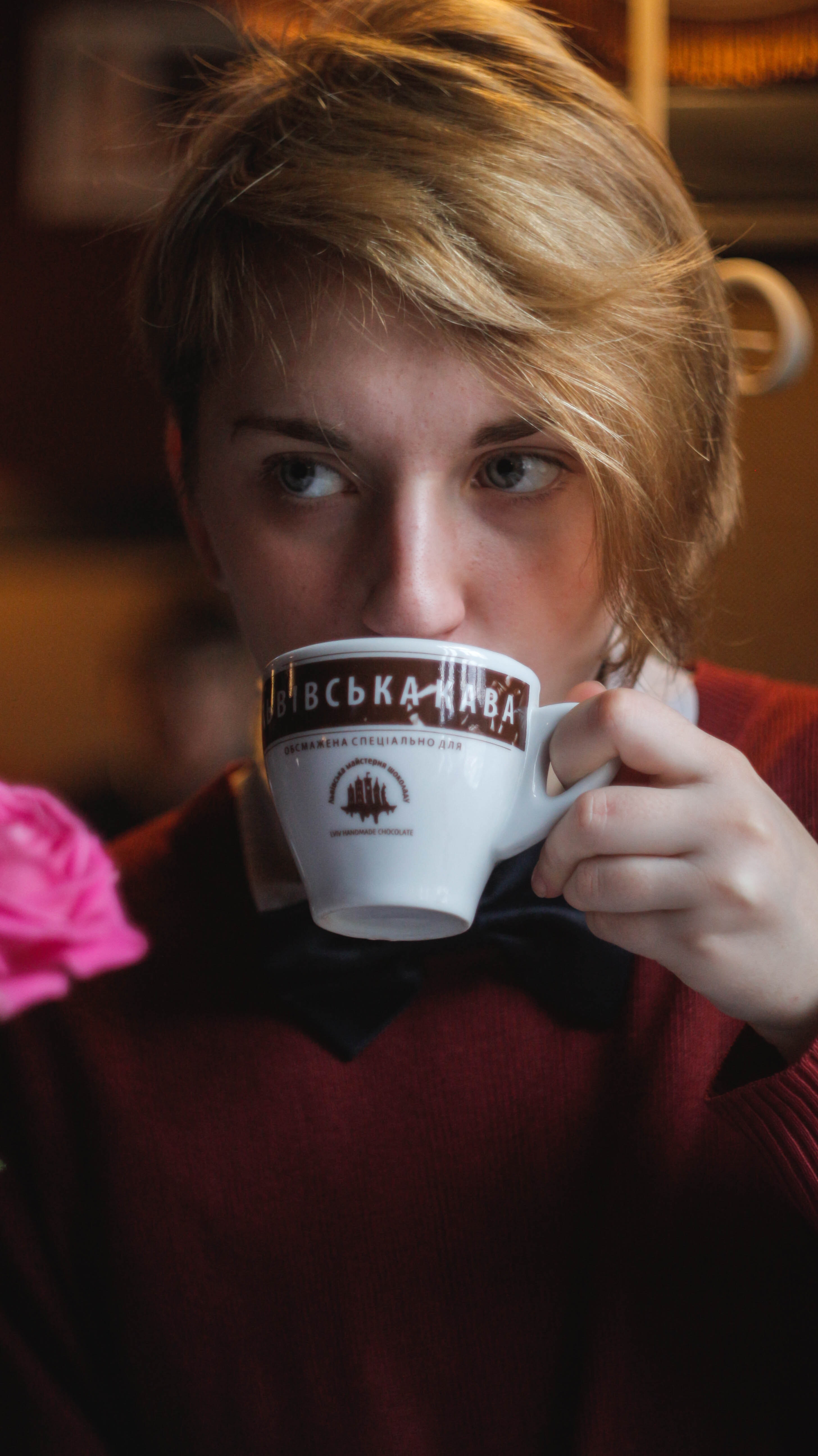 Woman wearing red top holding teacup photo