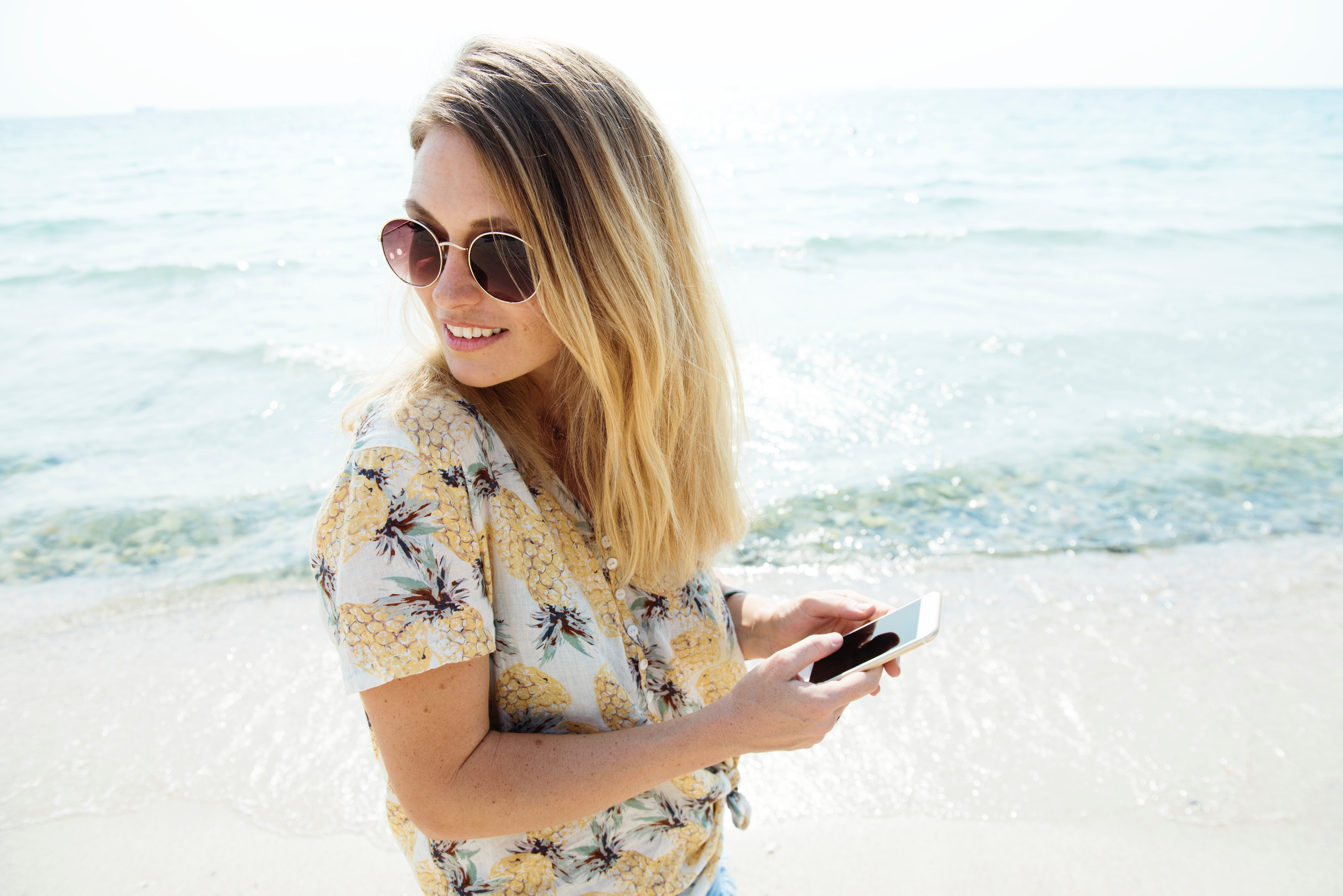 Woman wearing sunglasses at the beach photo