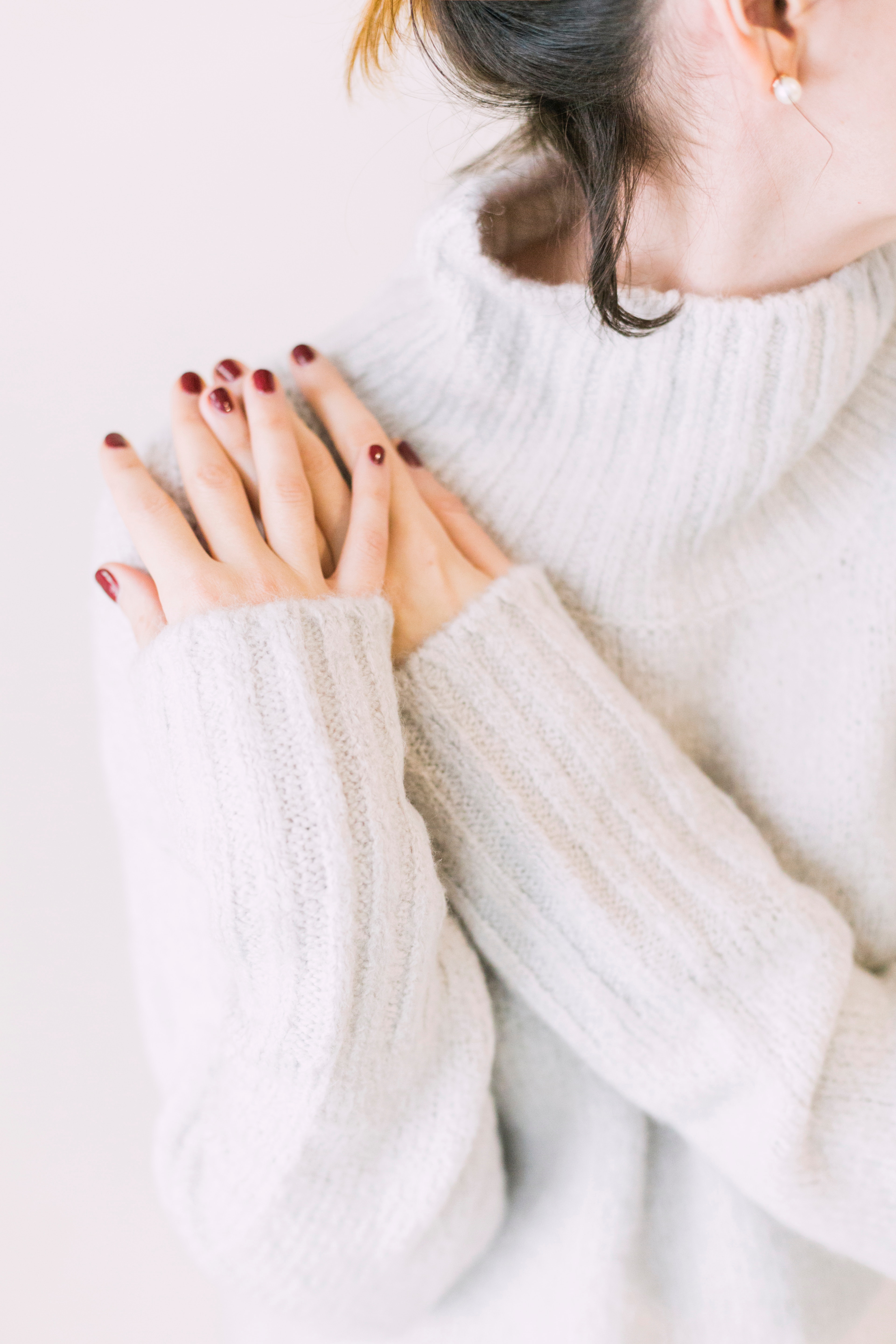 Woman wearing turtleneck sweater in white surface photo