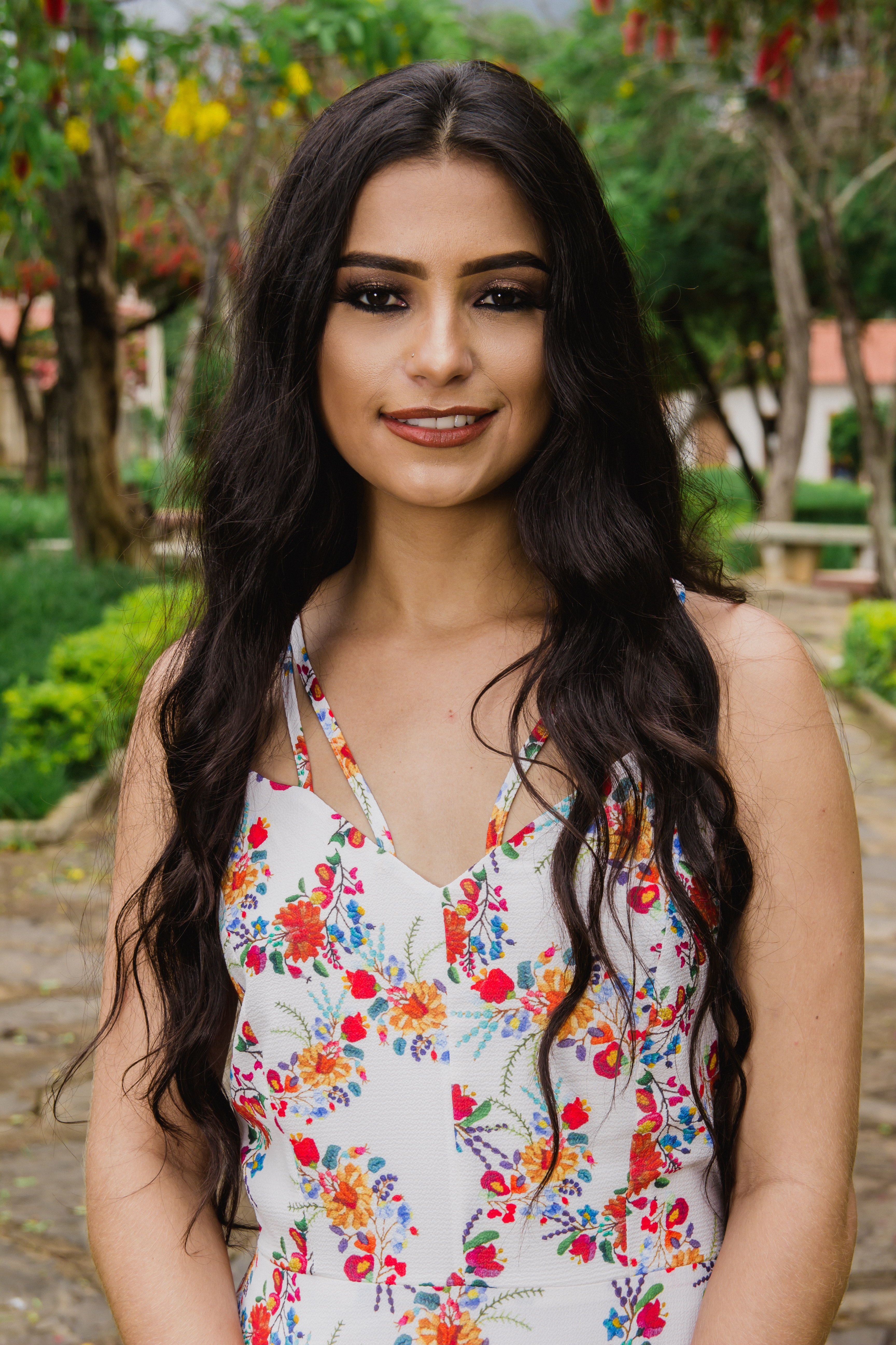 Woman wearing white and multicolored floral sleeveless top photo