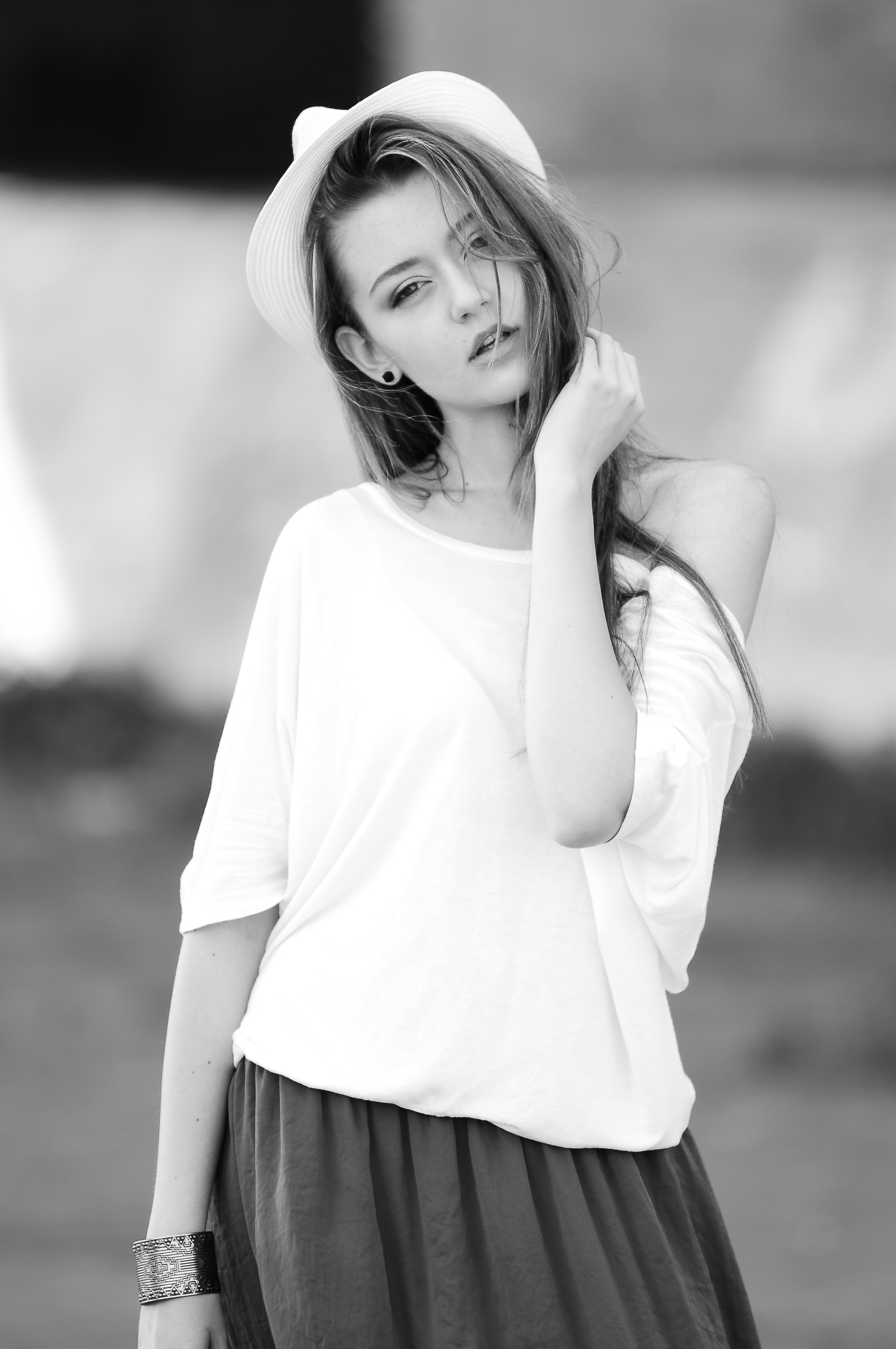 Woman wearing white off shoulder top in gray scale photo
