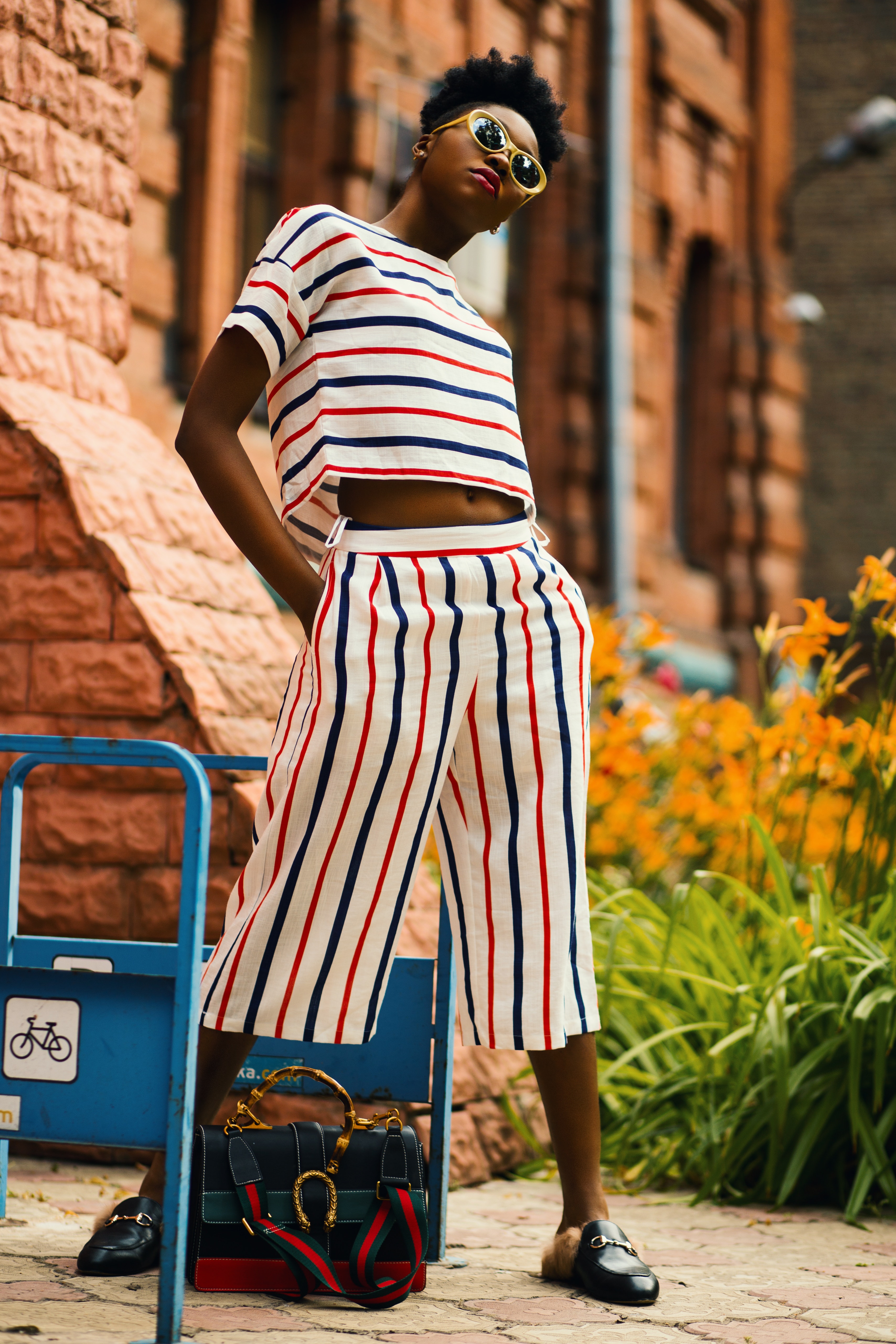 Woman wearing white-red-and-blue striped shirt and palazzo pants photo