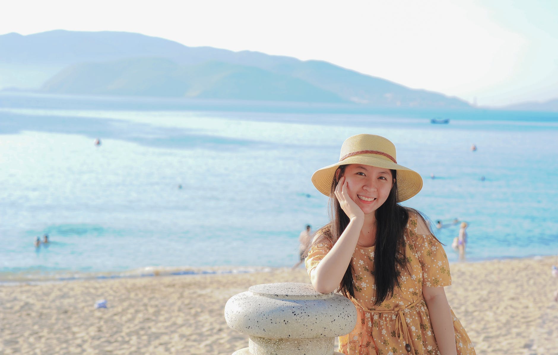 Woman Wearing Yellow Floral Dress and Sun Hat on Beach, Woman Wearing Yellow Floral Dress and Sun Hat on Beach