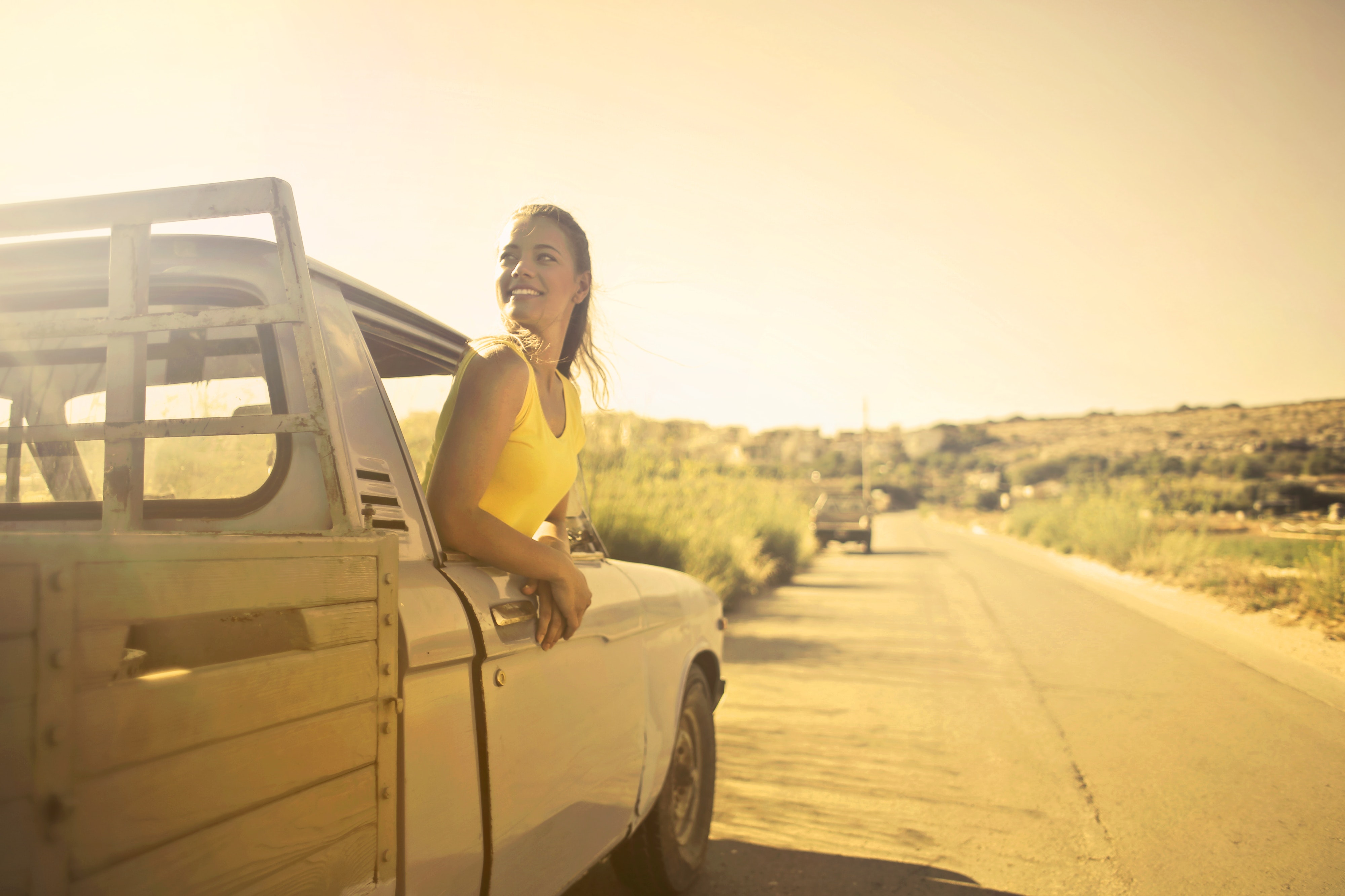 Woman wearing yellow shirt inside pickup truck photo