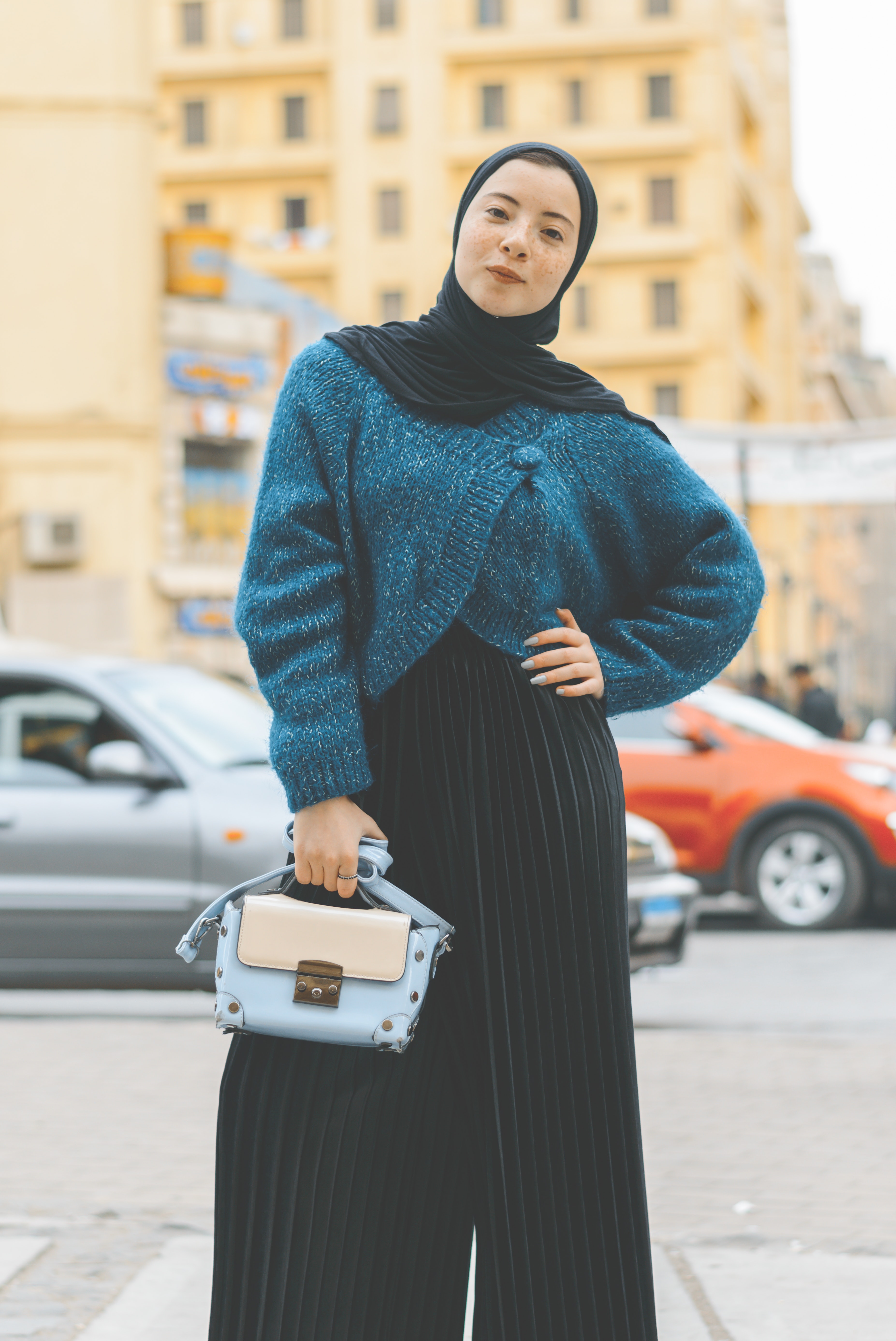 Woman wears blue and black sweater with pants photo