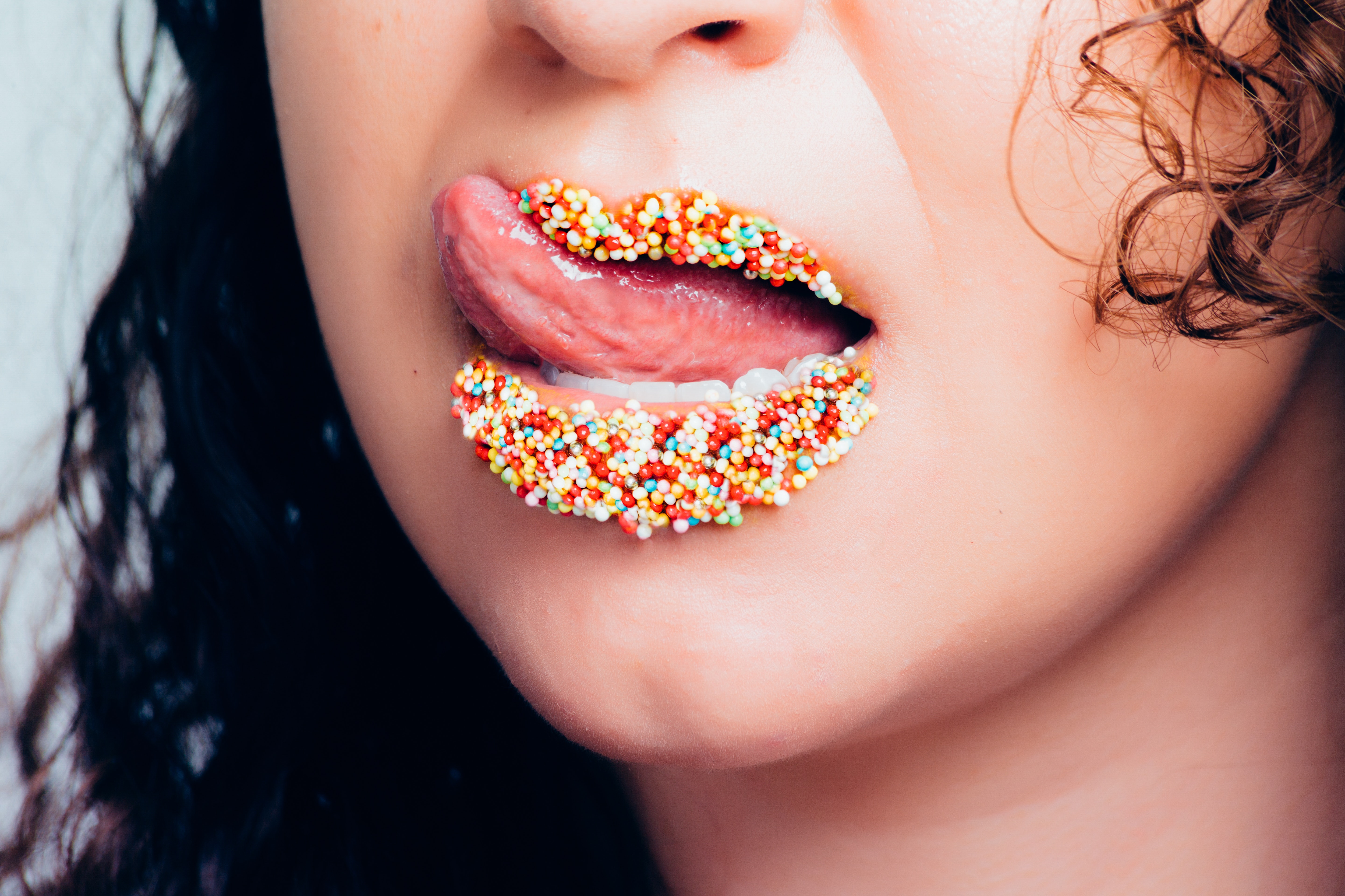 Woman with candy sprinkles on lips photo
