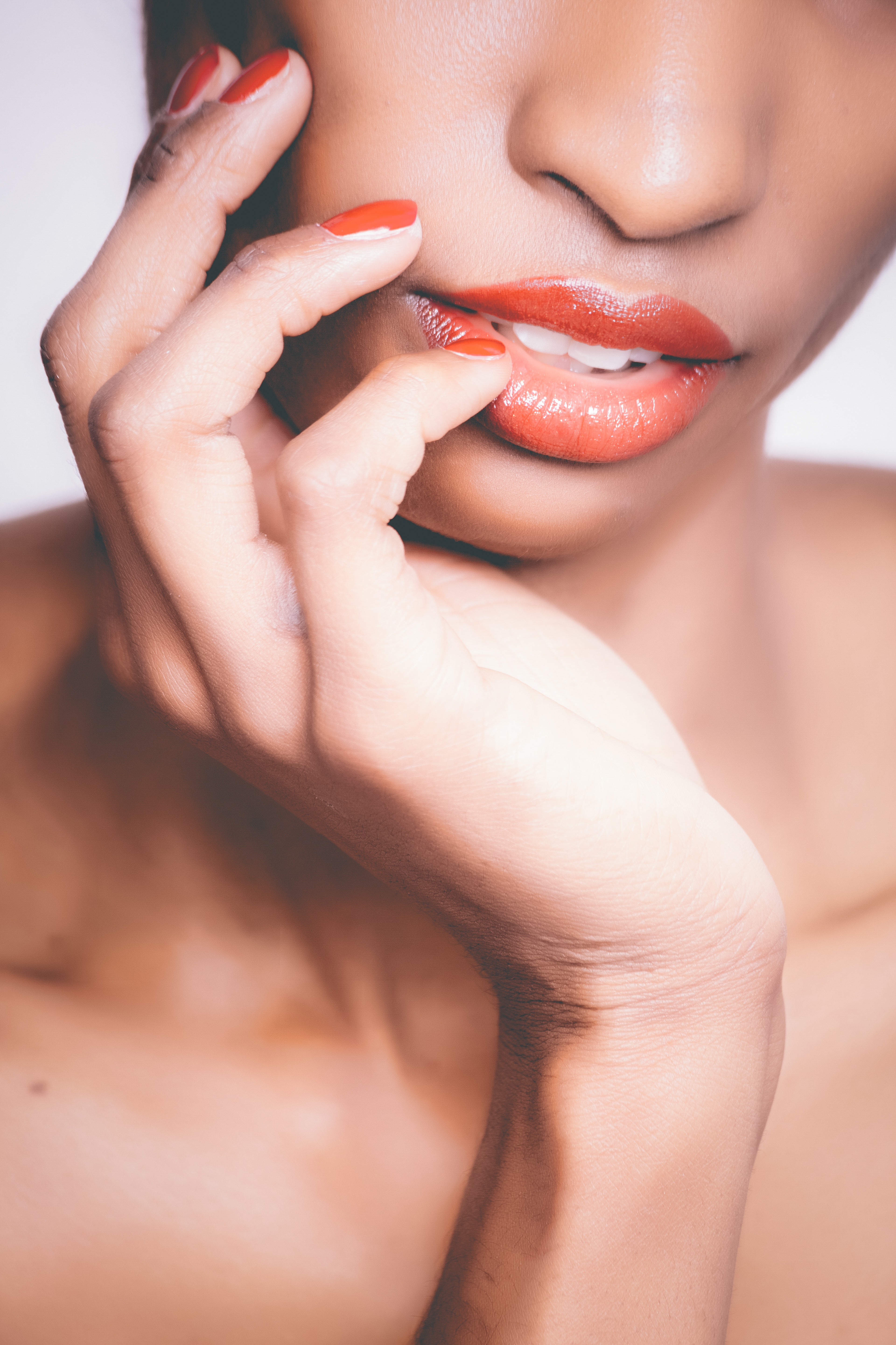 Woman with orange lipstick and manicure taking selfie photo