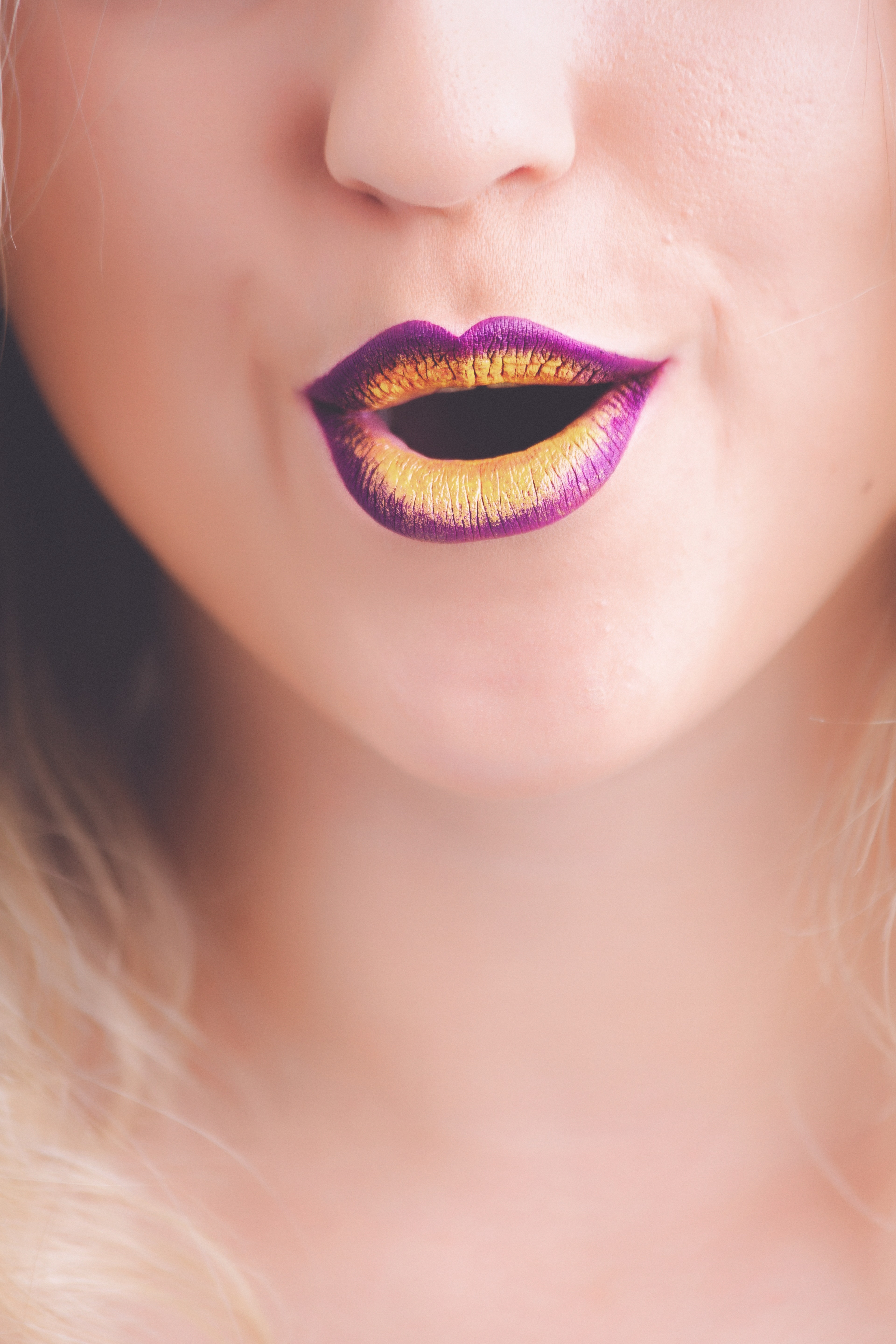 Woman with purple and yellow lipstick photo