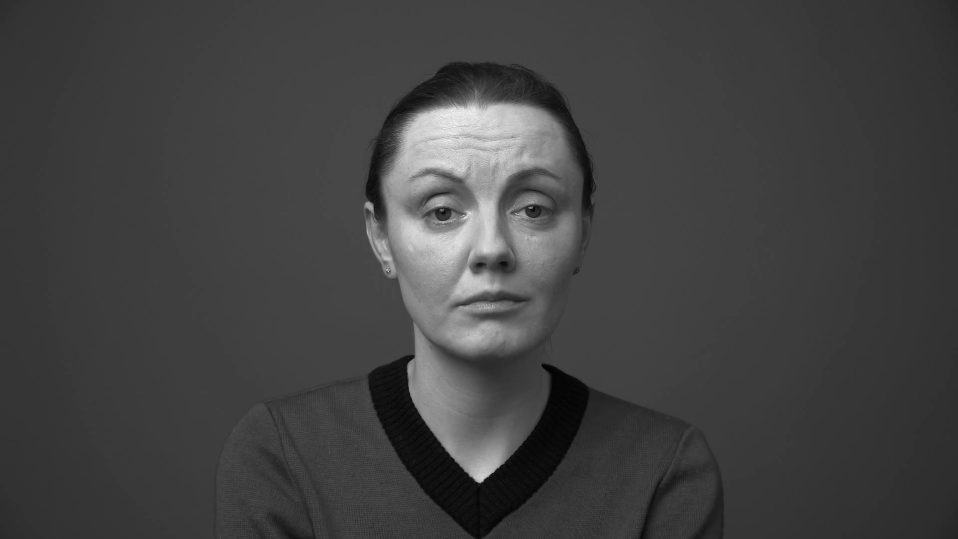 Sad woman's face, eyes are lowered, zoom in, gray background Stock ...