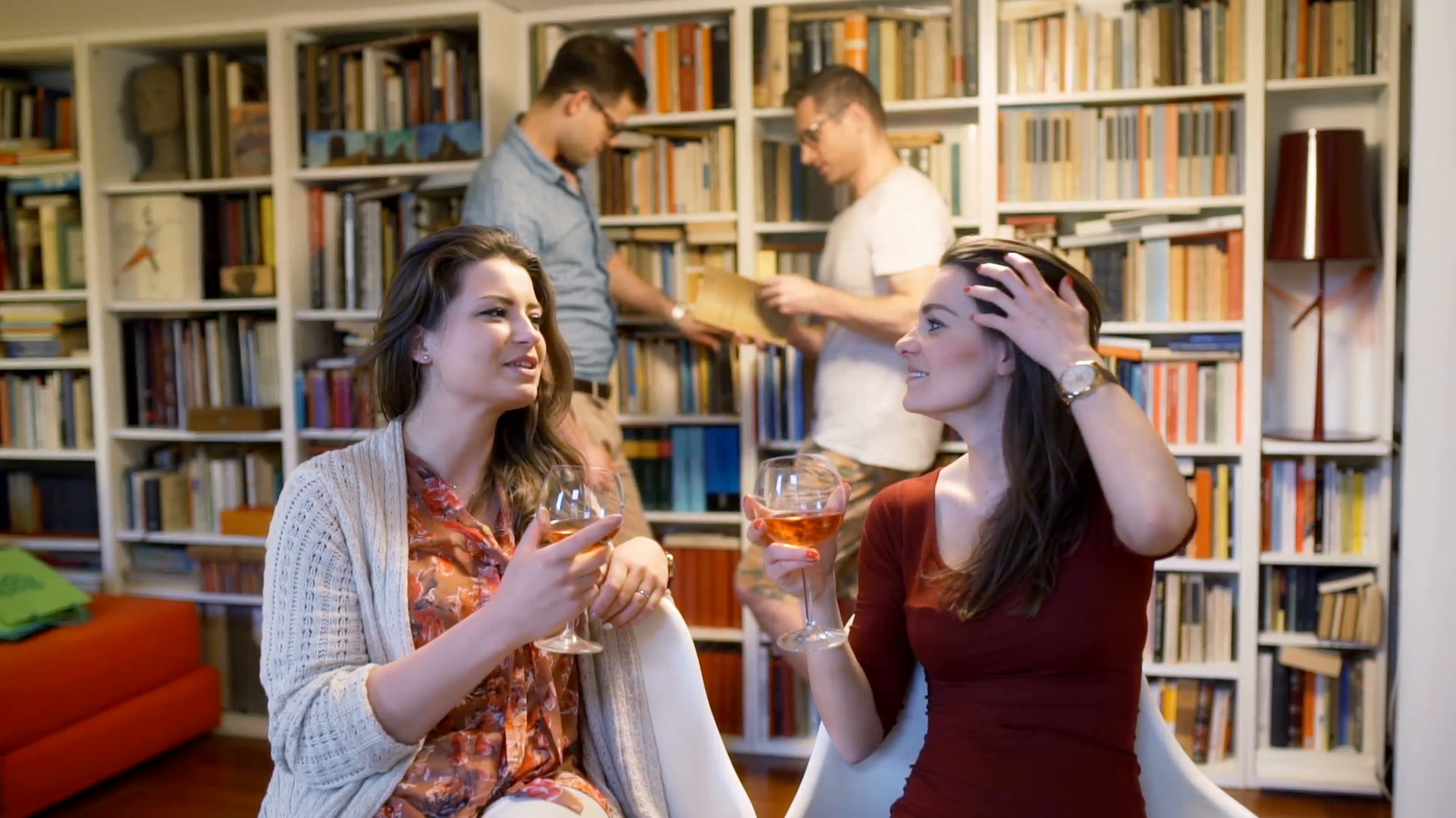 Women drinking wine and men looking at books on the party Stock ...
