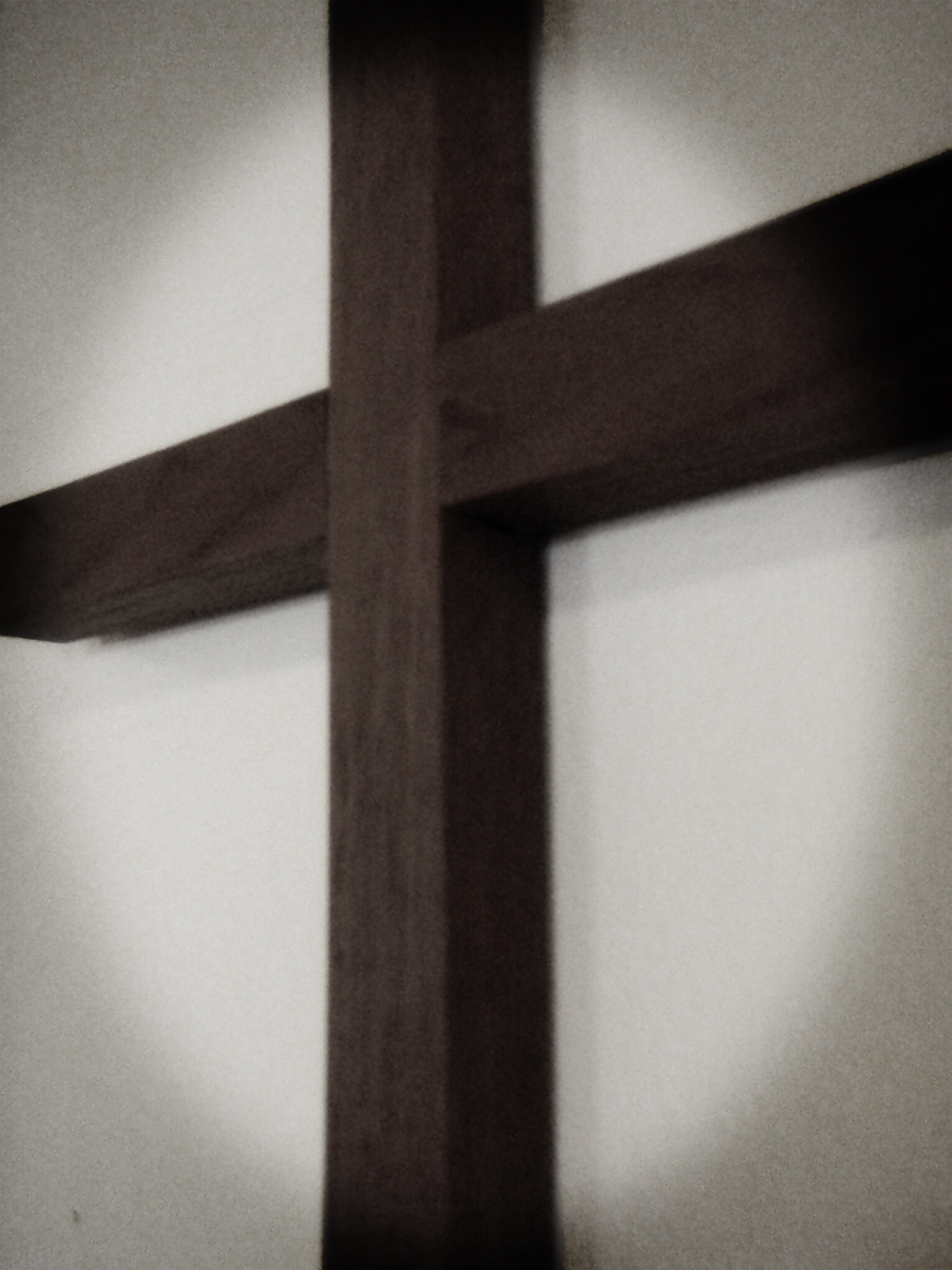 Wooden cross on the wall photo