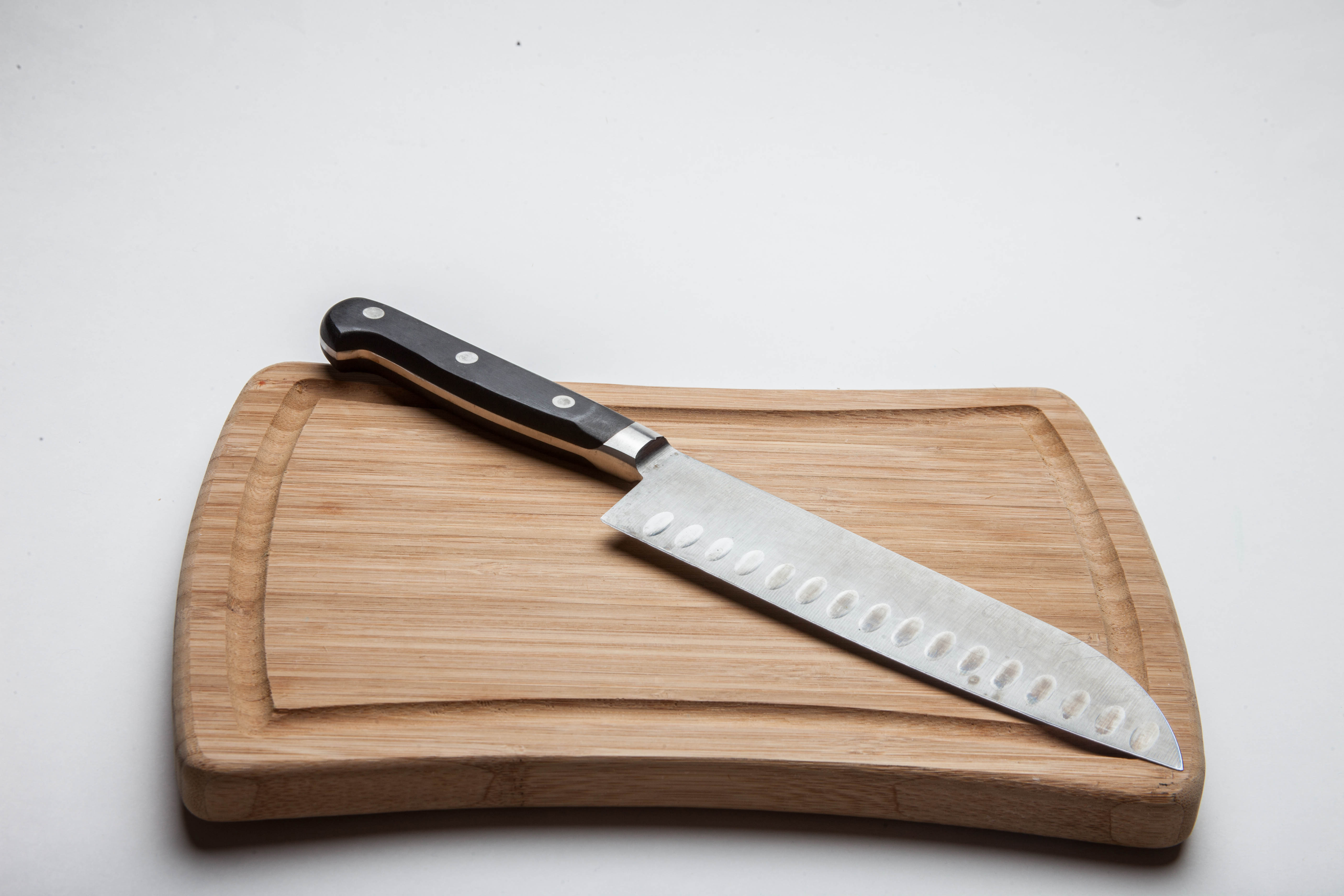 Wooden cutting board with knife photo