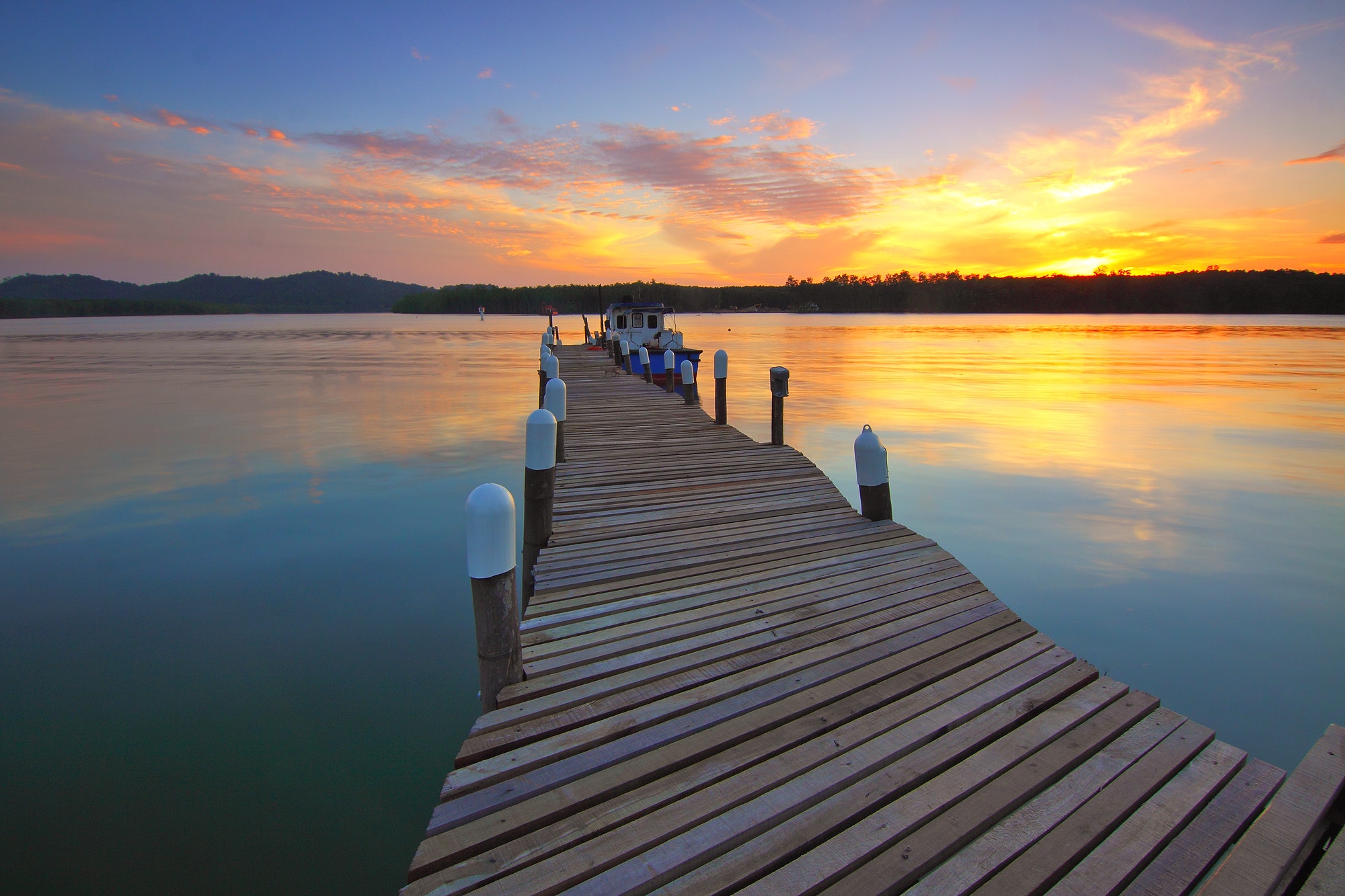 Wooden dock at sunset view photo
