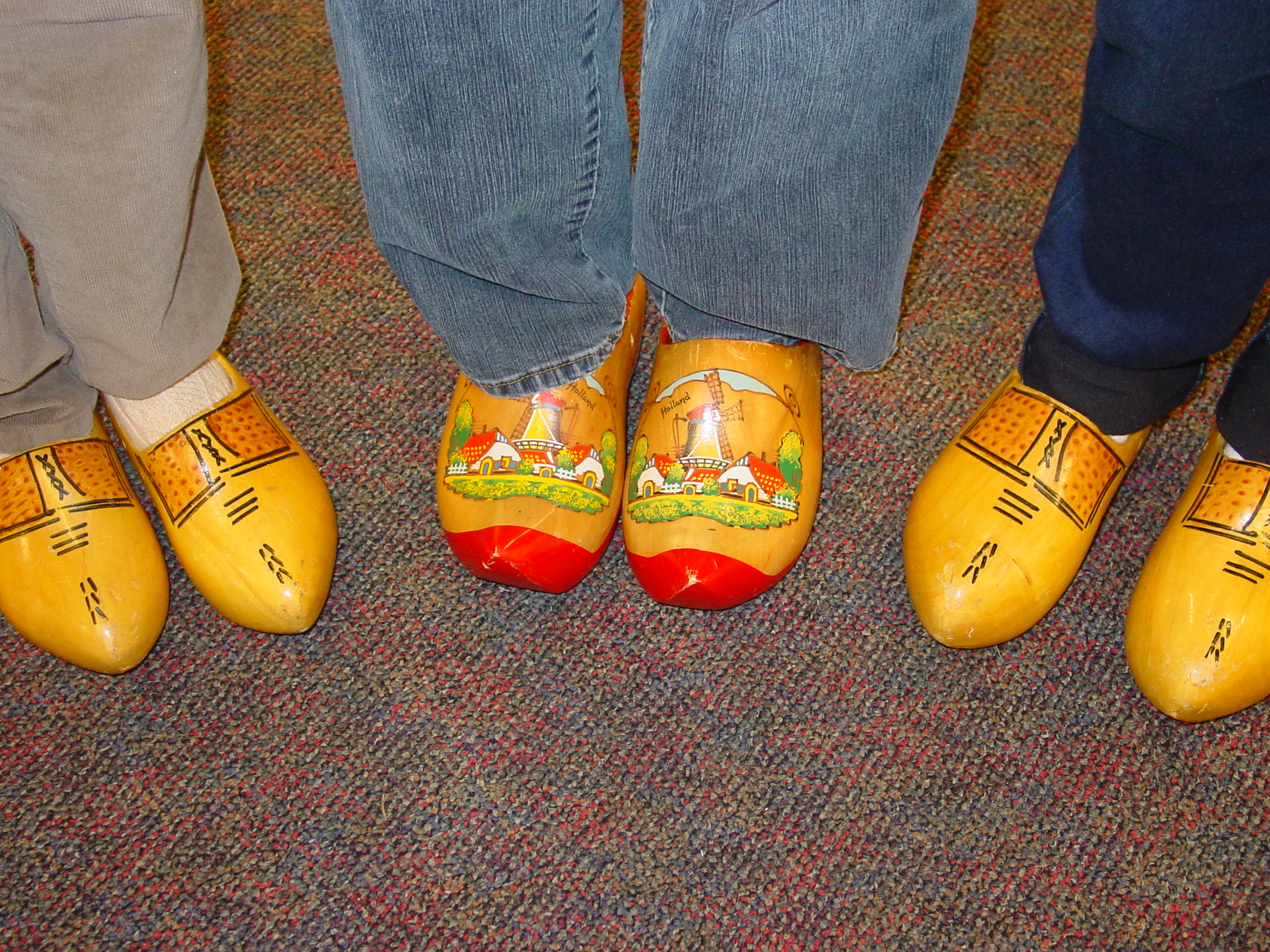 Volunteers try on donated wooden shoes – Mt Joy Gift & Thrift