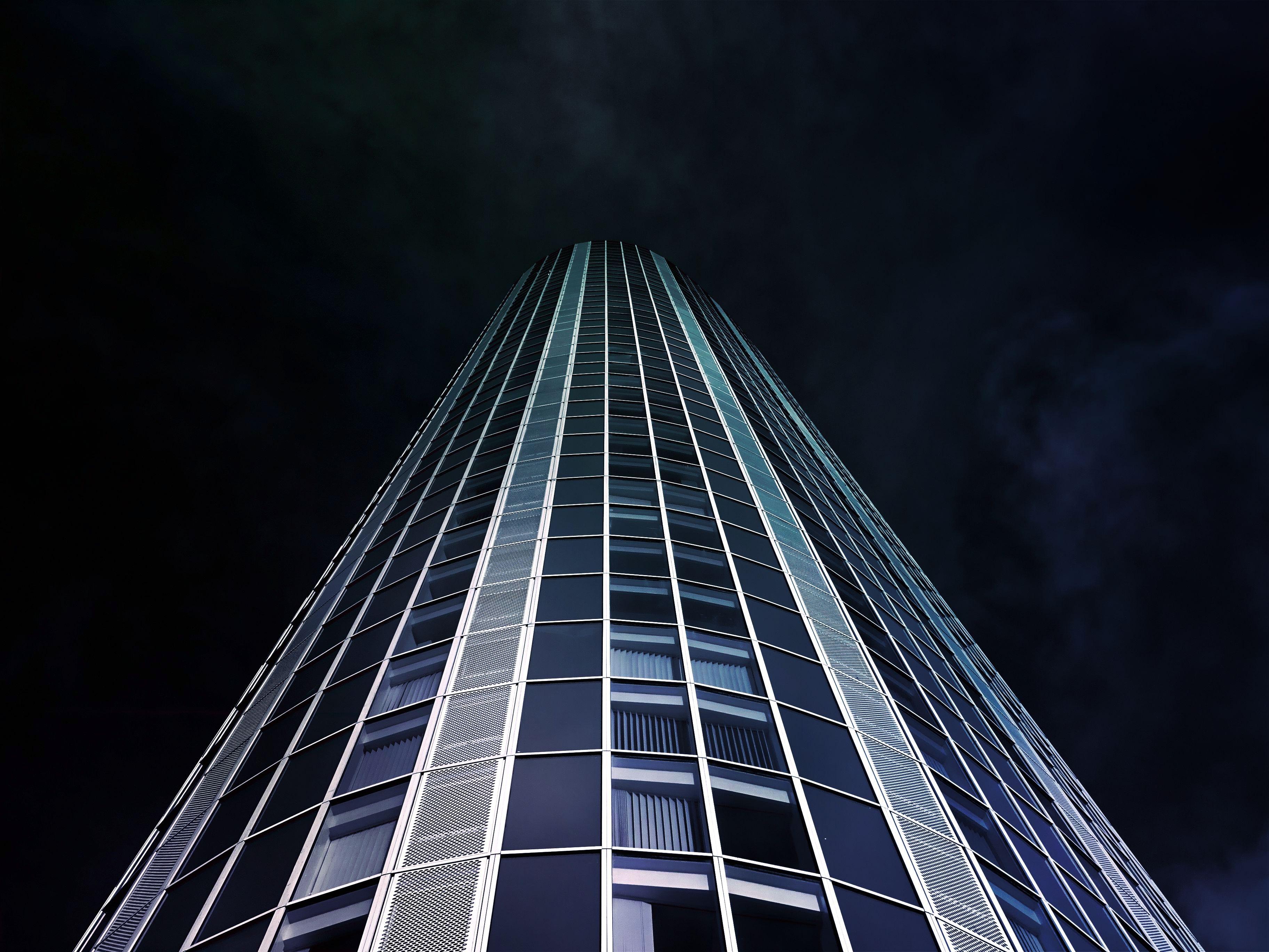 Worm's eye view of high-rise building during nighttime photo