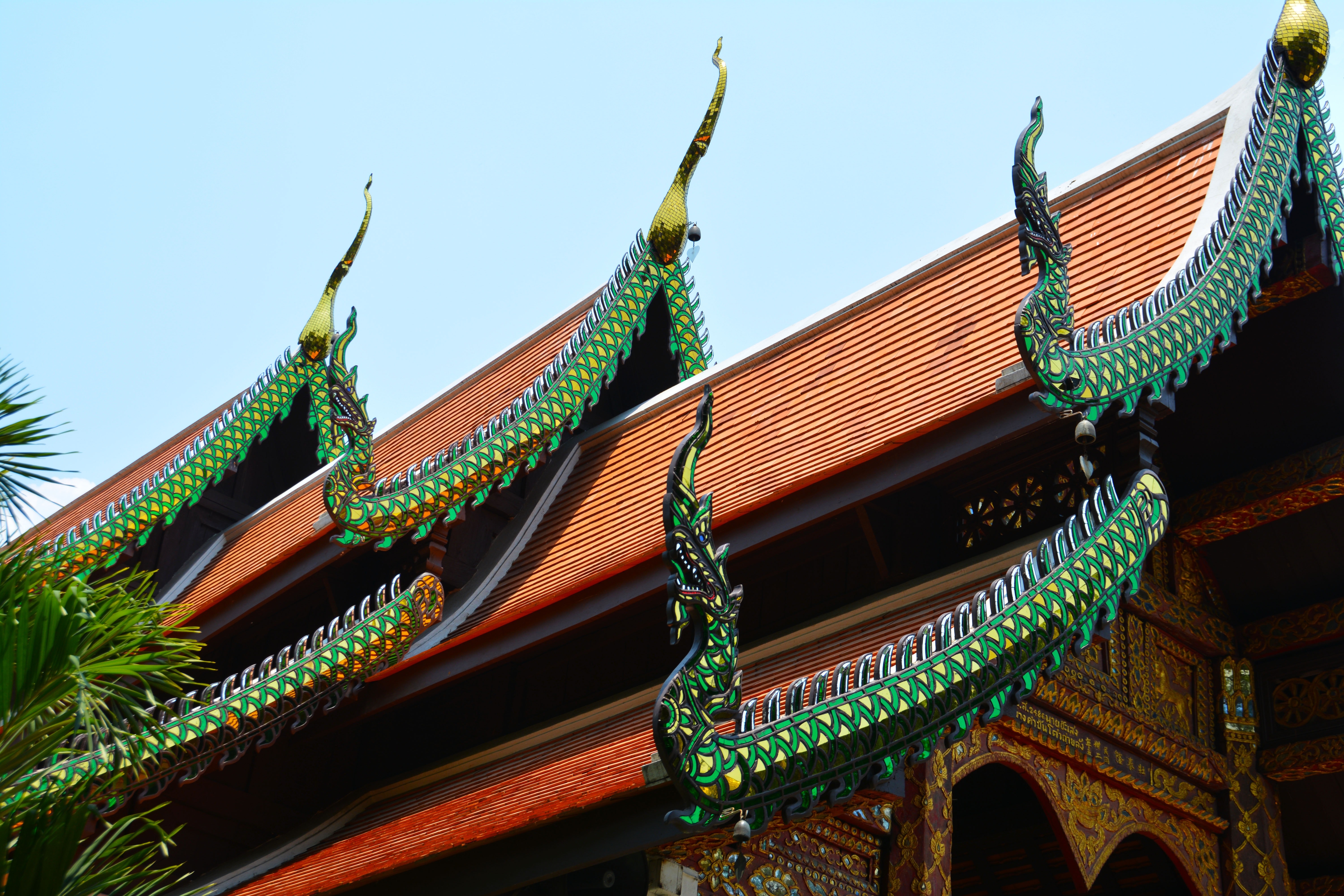 Worms eye view of green and orange temple photo