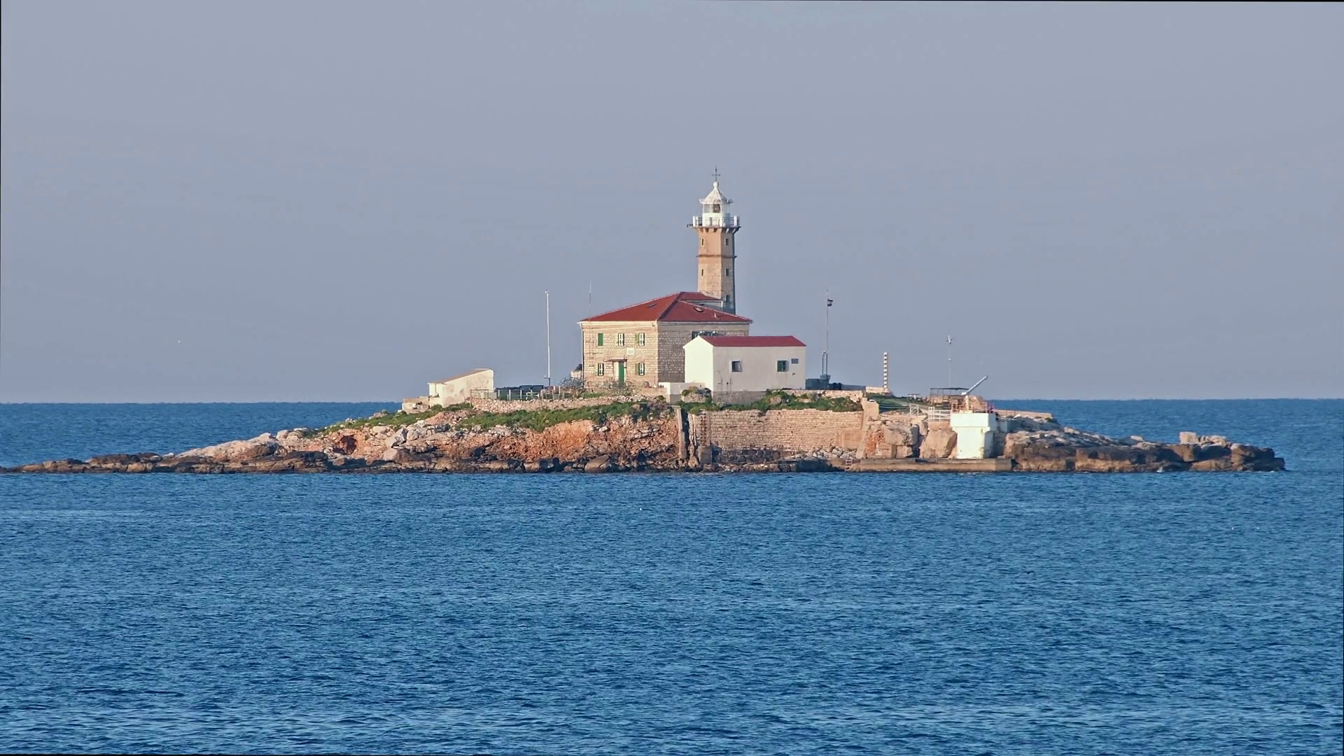 Lighthouse on small island in sunrise. The island is called Sveti ...