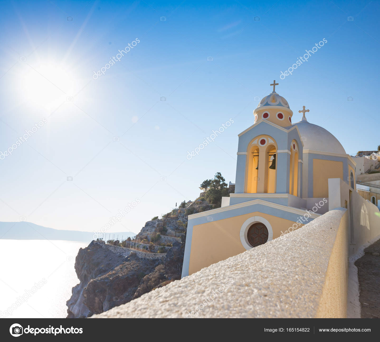 Beautiful yellow church dome on the edge of the town of Fira ...