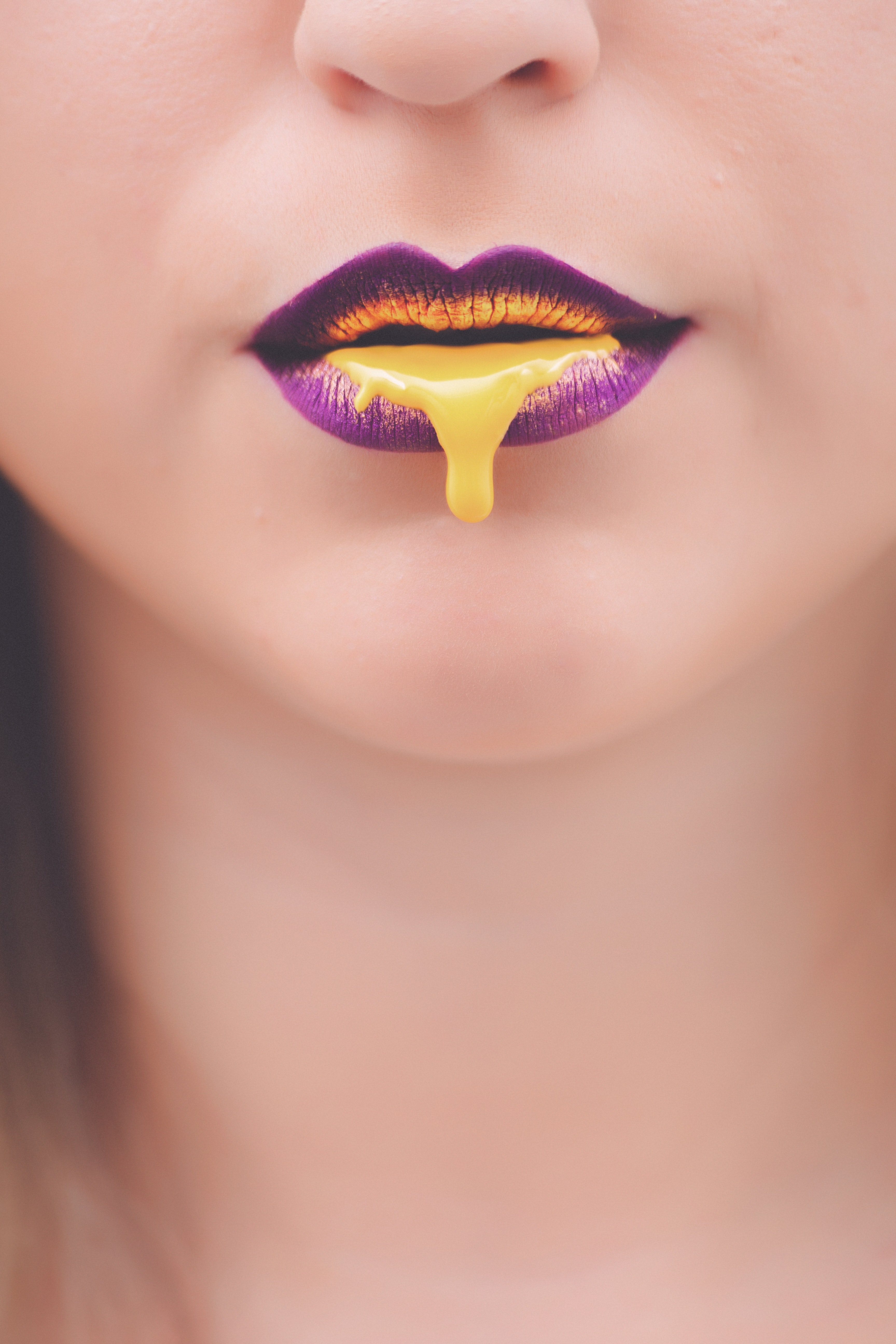Yellow liquid on woman's lips photo