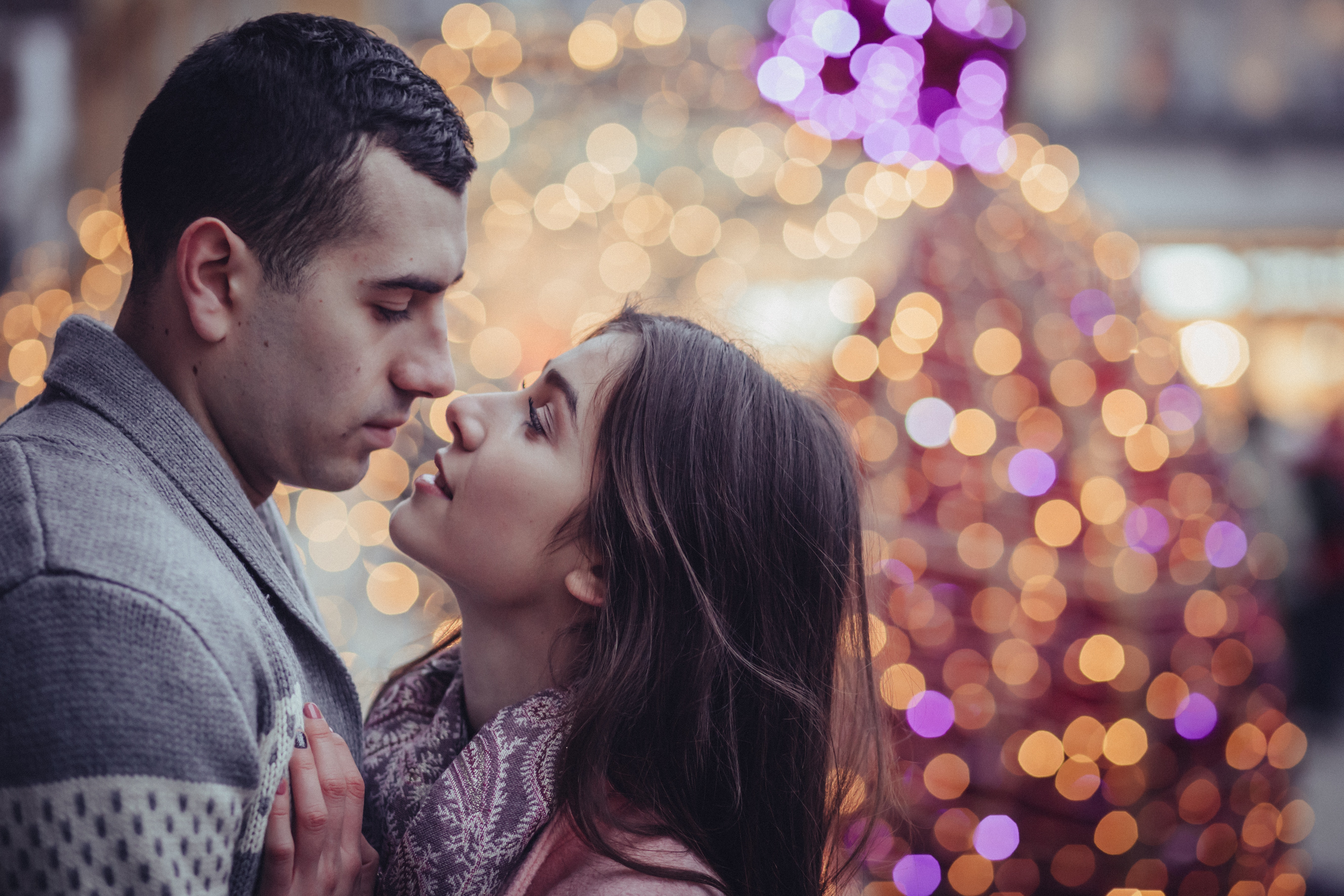 Young couple kissing in city at night photo