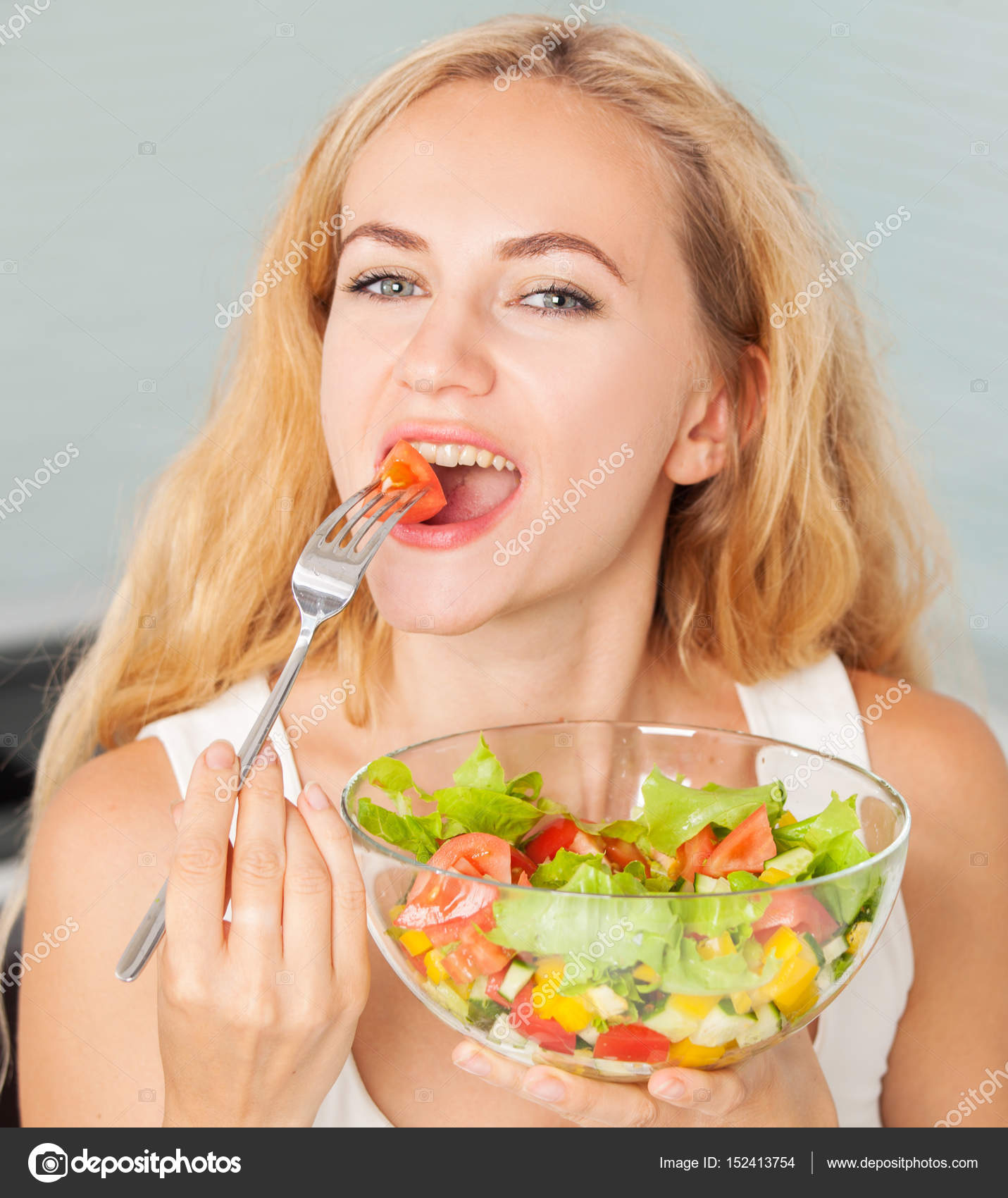 Young woman eating vegetable salad — Stock Photo © TatyanaGl #152413754
