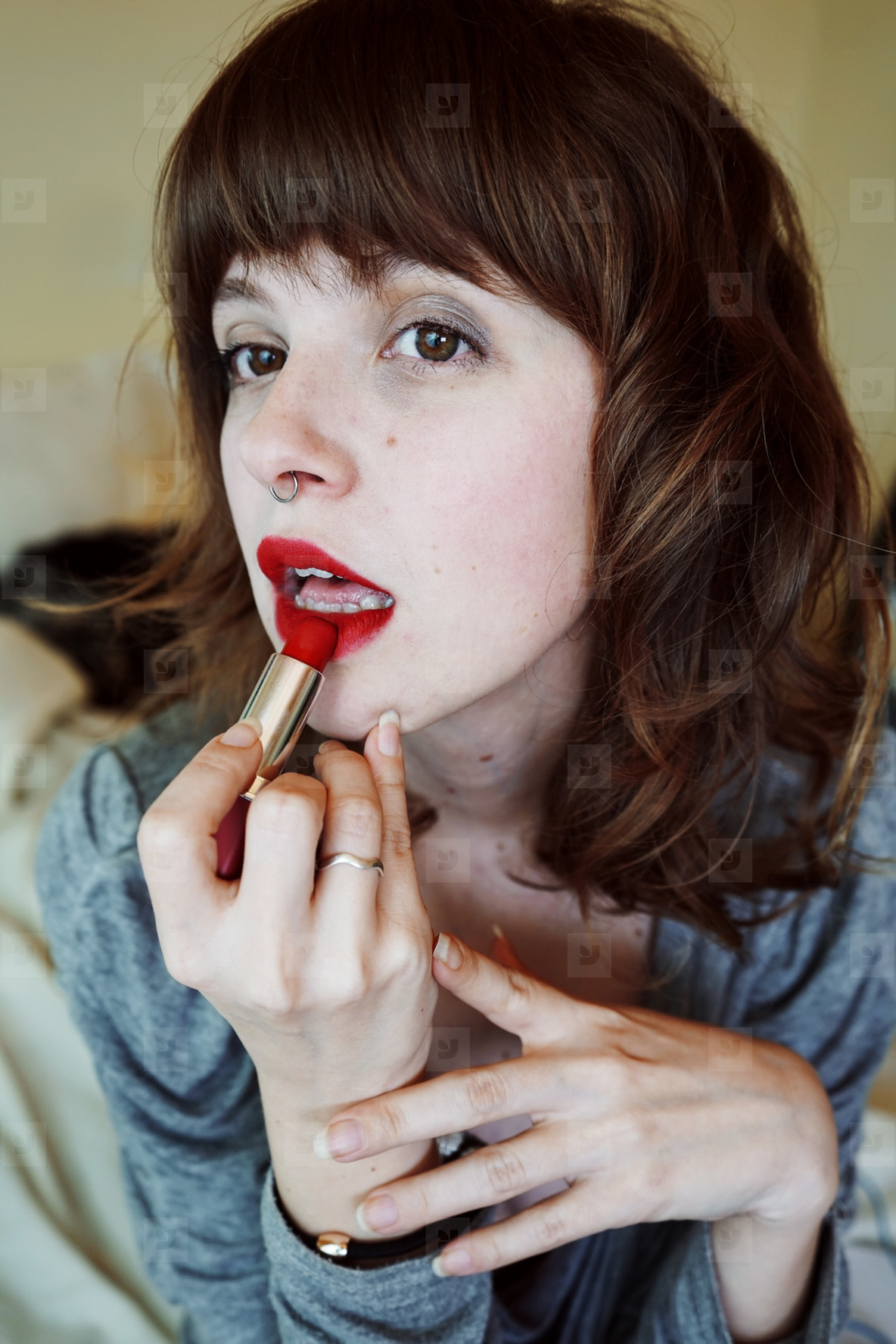 Photos - Young woman painting her lips - YouWorkForThem