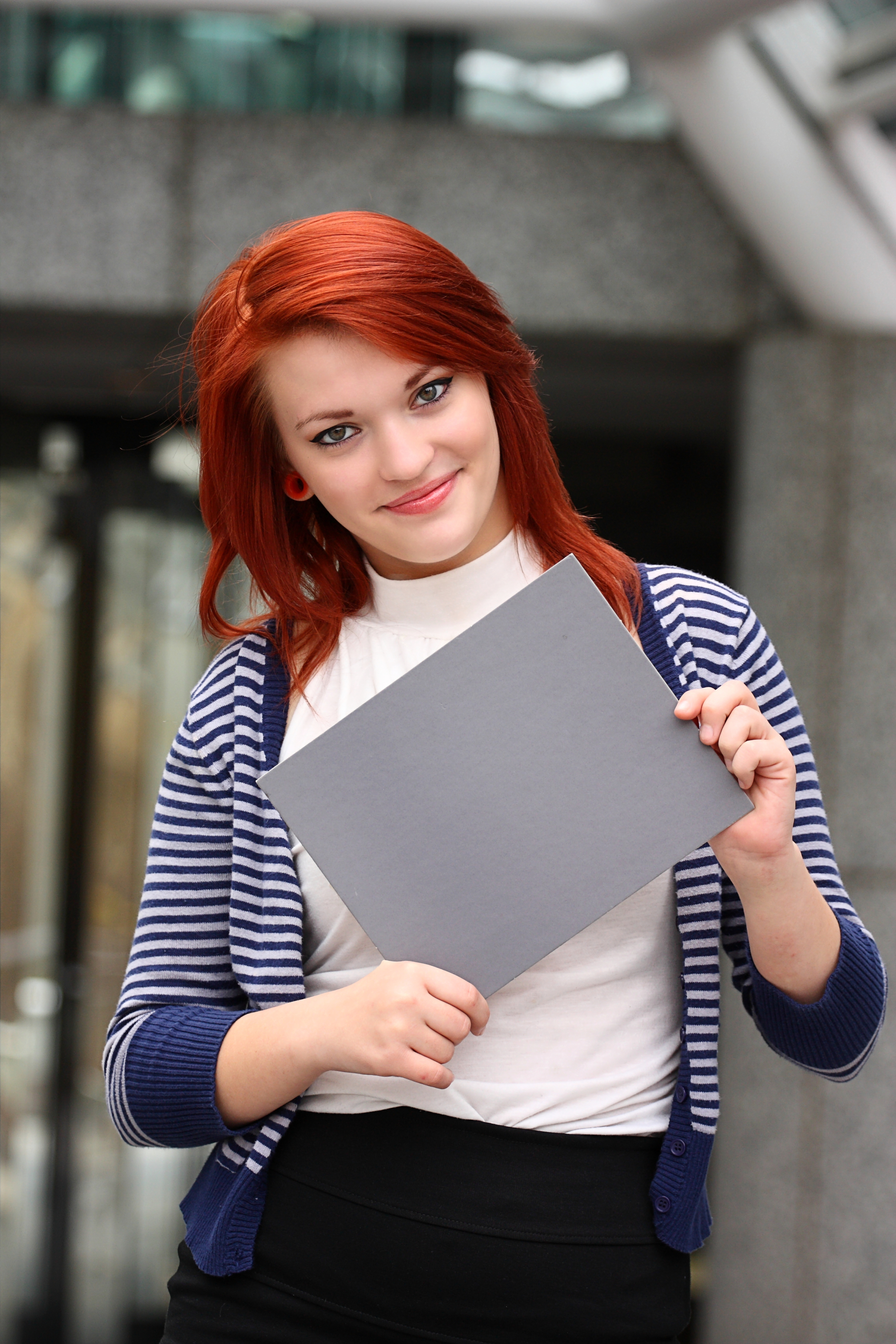 Young woman holding a blank card photo