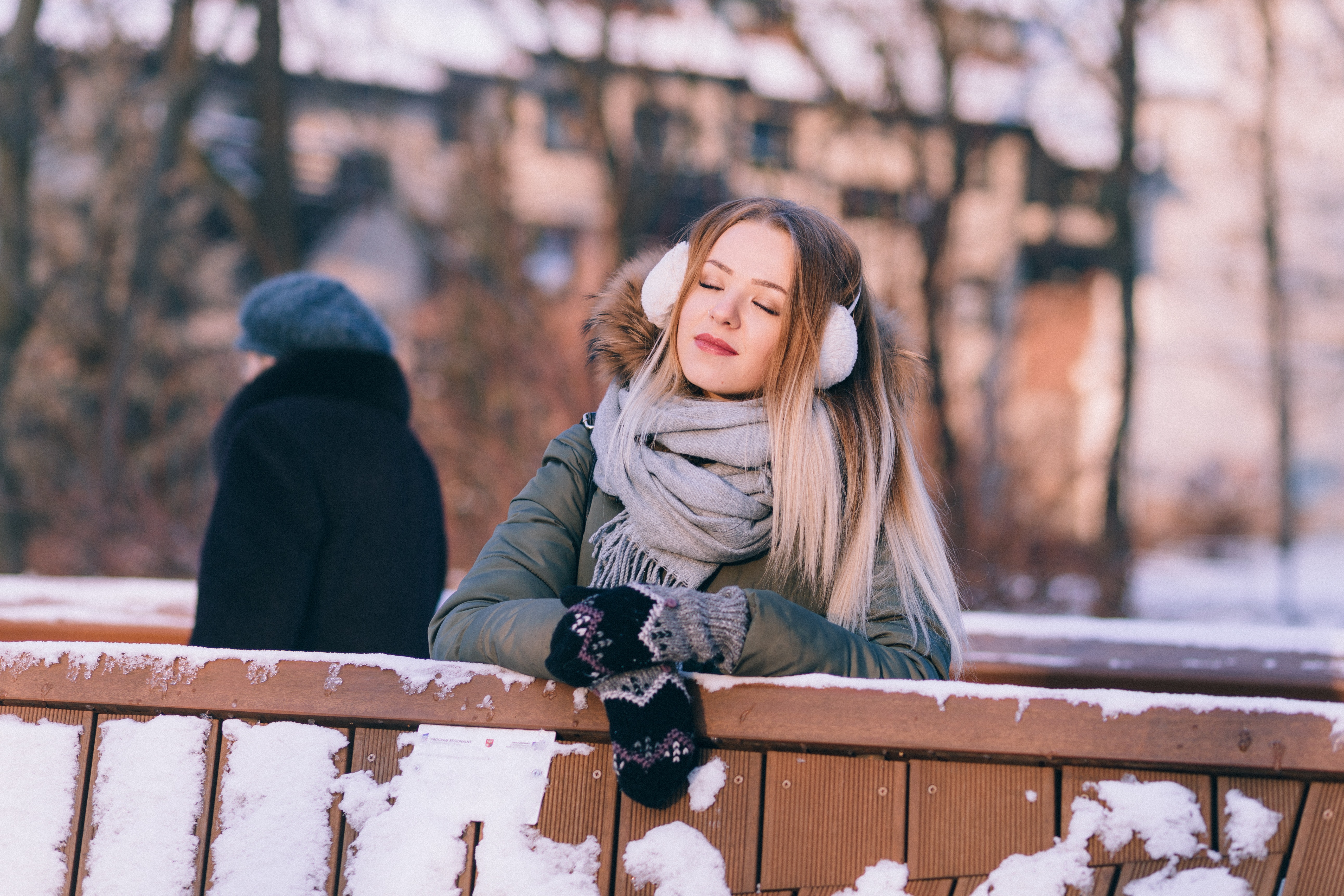 Young woman sitting on bench in winter photo