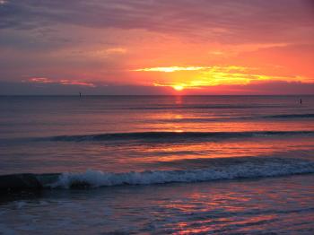 A beach and ocean sunset