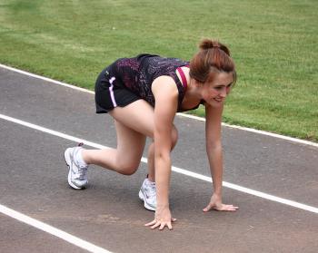 A cute young girl on a track field