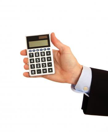 A hand holding a calculator