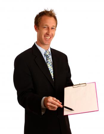 A young businessman holding a clipboard