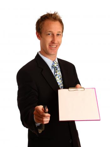 A young businessman holding a clipboard