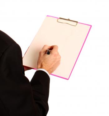 A Young Businessman Holding A Clipboard