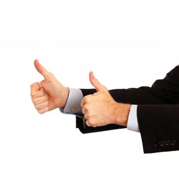 A young businessman making a thumbs up g