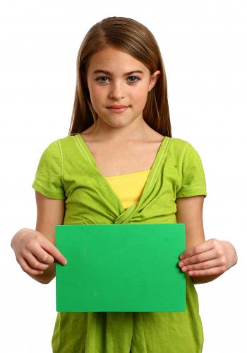 A young girl holding a blank sign