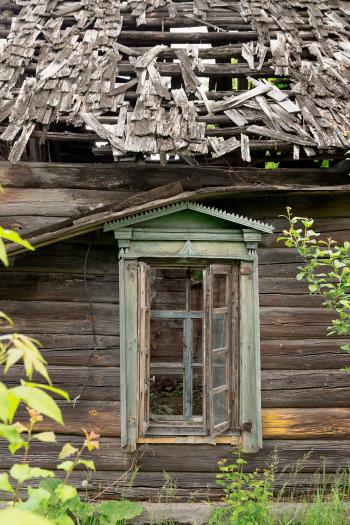 Old abandoned wooden house with a broken window, close-up. - An old ...